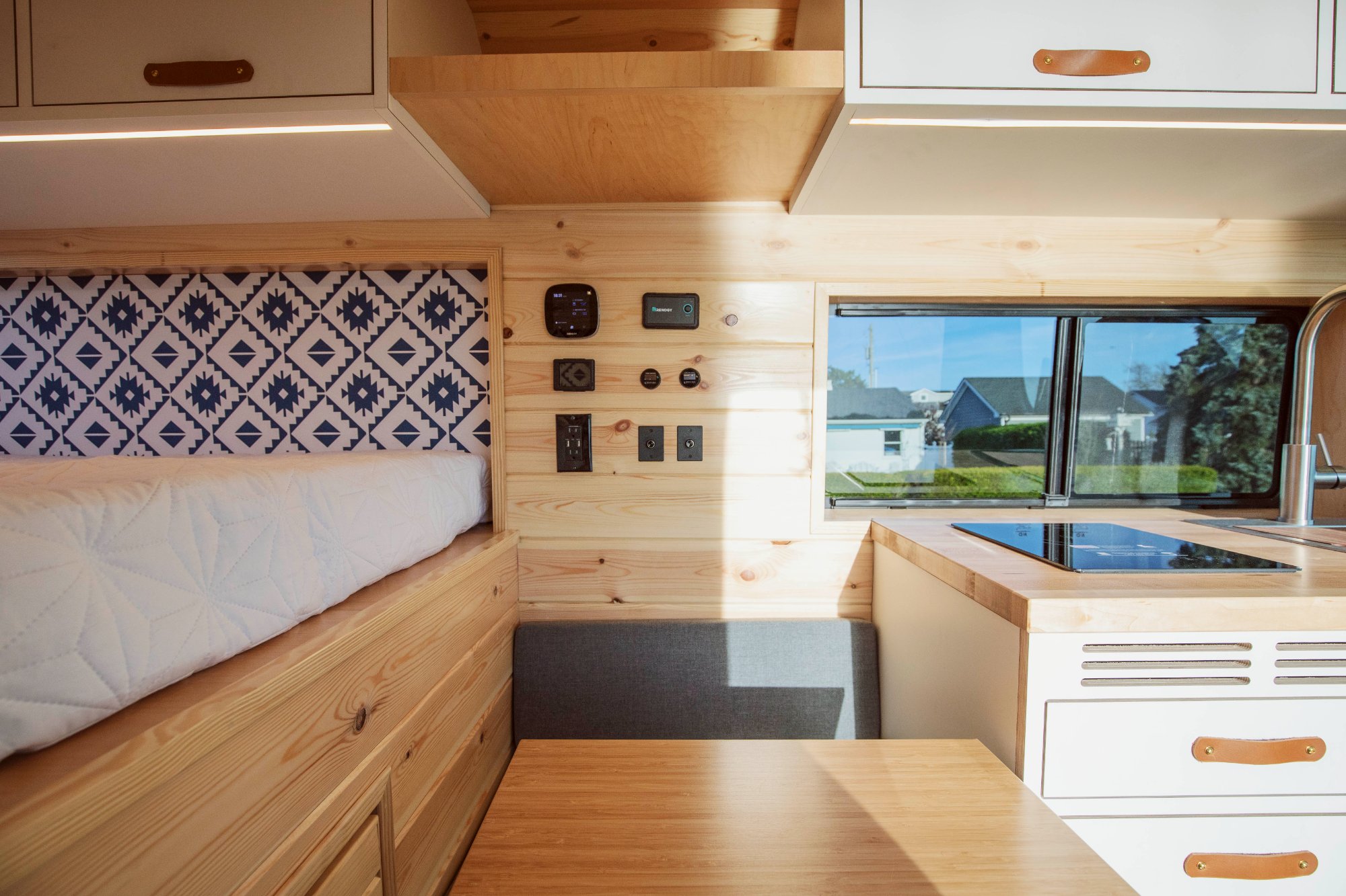 Interior with lounge, bed, kitchen and controls