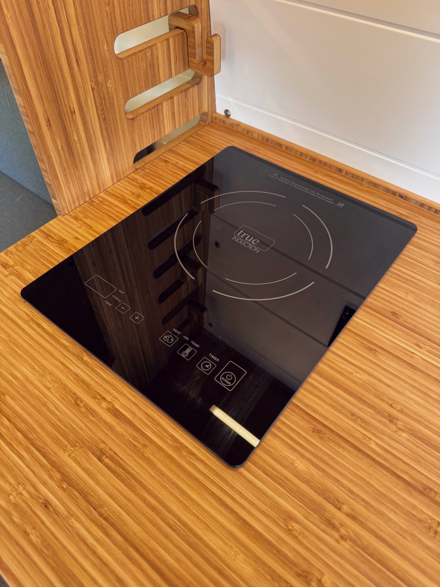 Loft — True Induction cooktop flush in bamboo counter