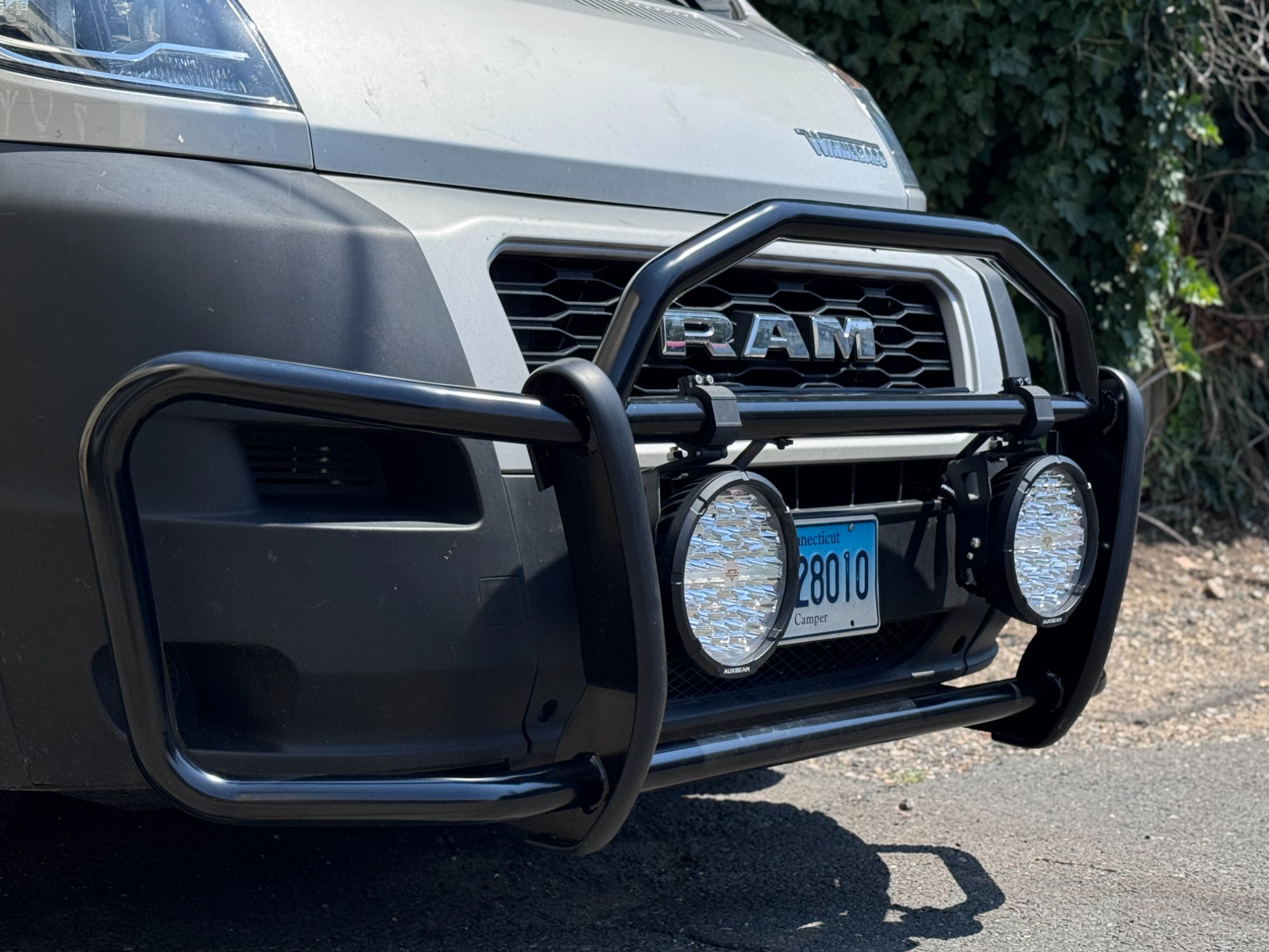 Custom front bull bar with dual Auxbeam round LED lights installed on camper van front end