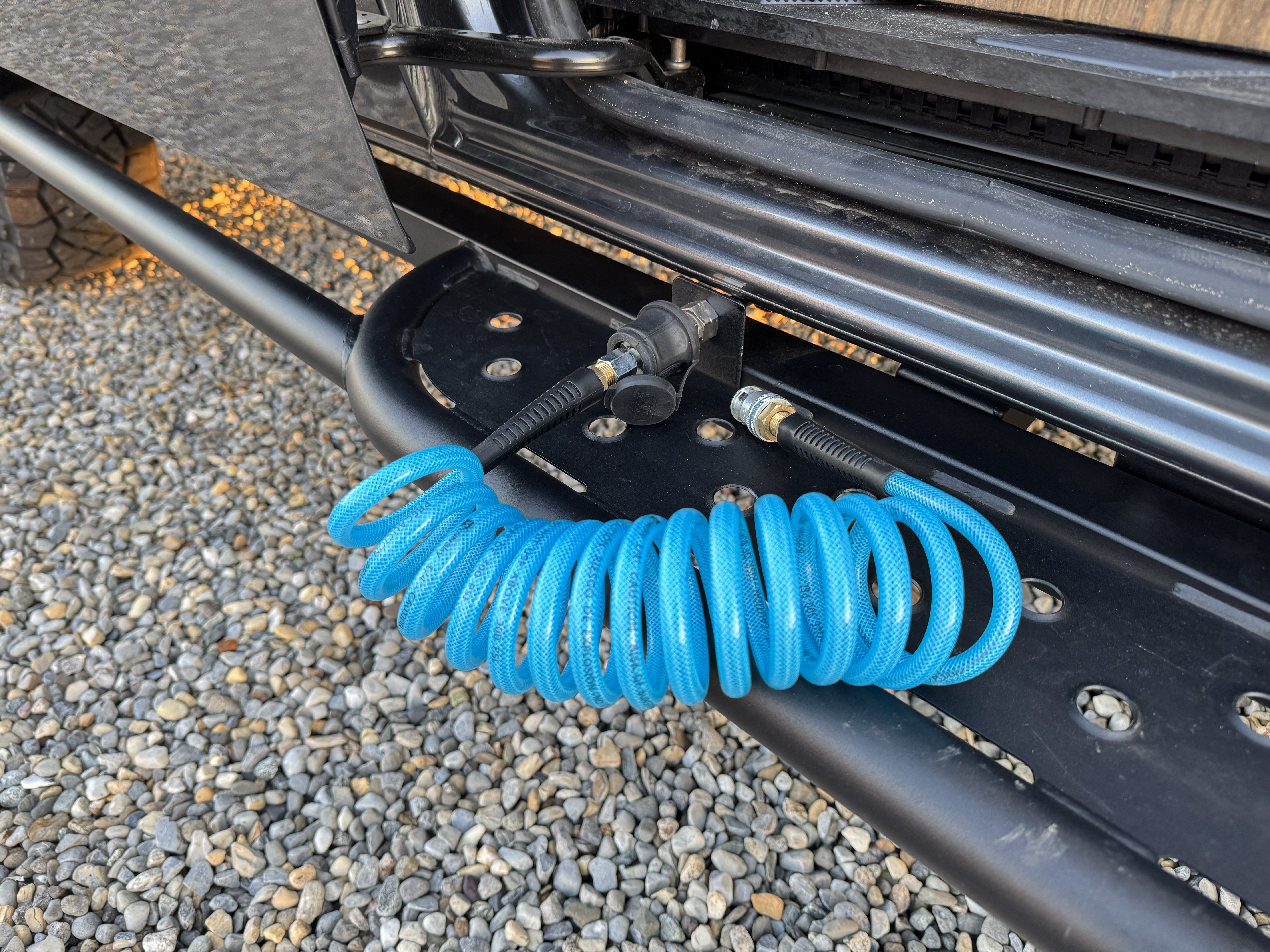 Baja Sprinter 170 4x4 — coiled blue air hose and rear-bumper ARB air compressor outlet for off-road tire reinflation