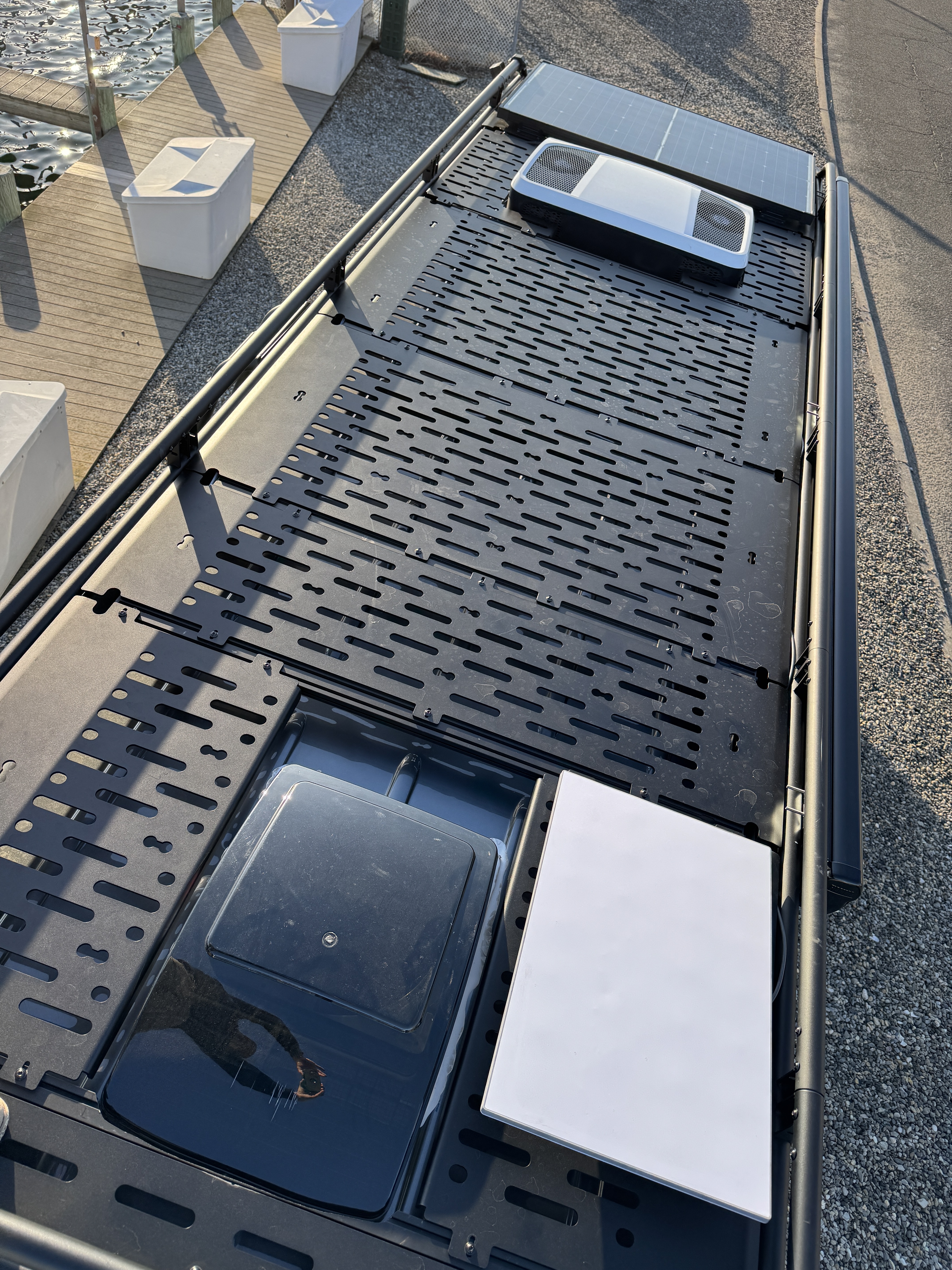 Baja Sprinter 170 4x4 — overhead view of roof rack with solar panel, MaxAir fan, air conditioner, and skylight