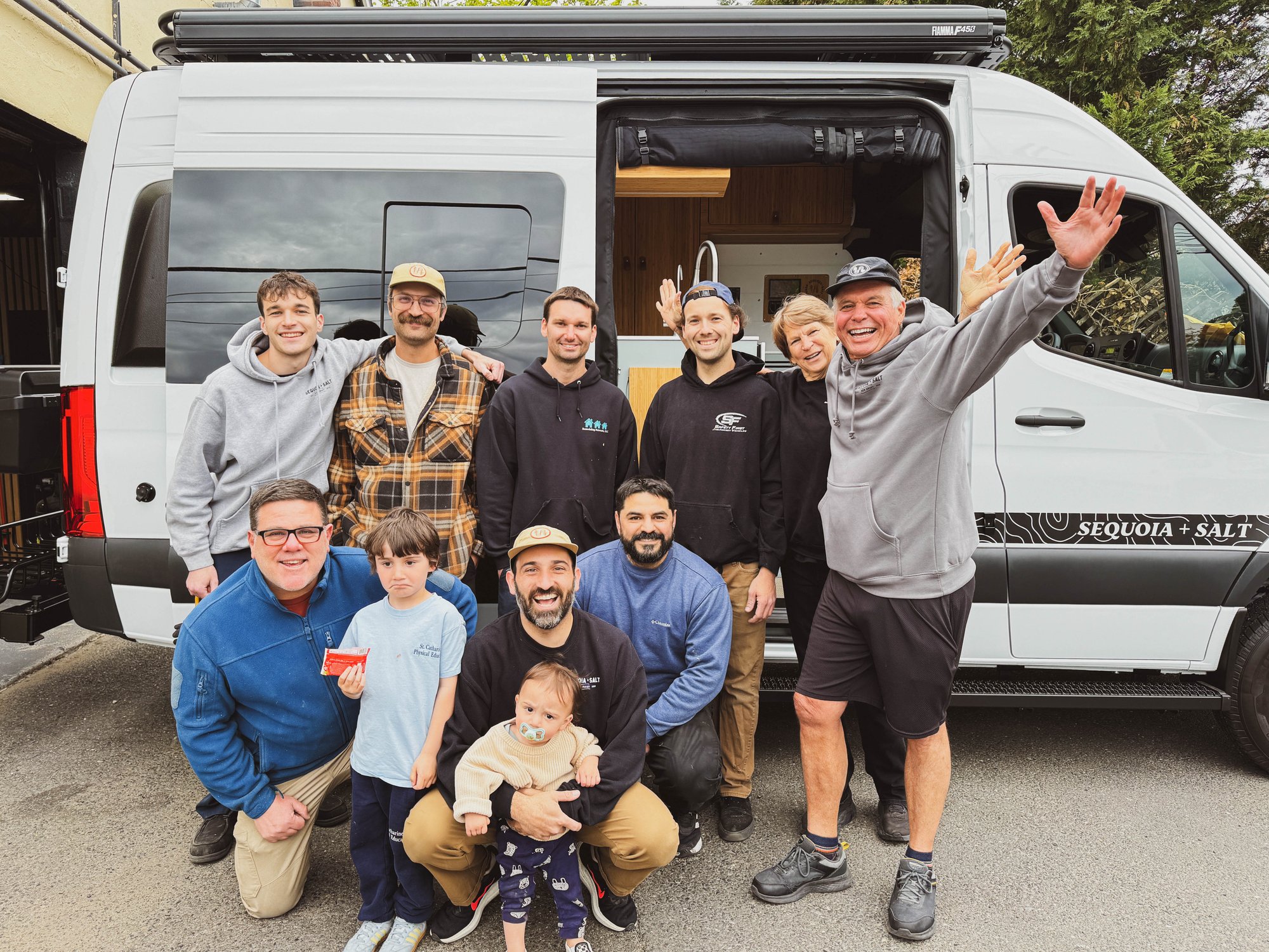 The Sequoia + Salt team with a customer and their family in front of a finished build