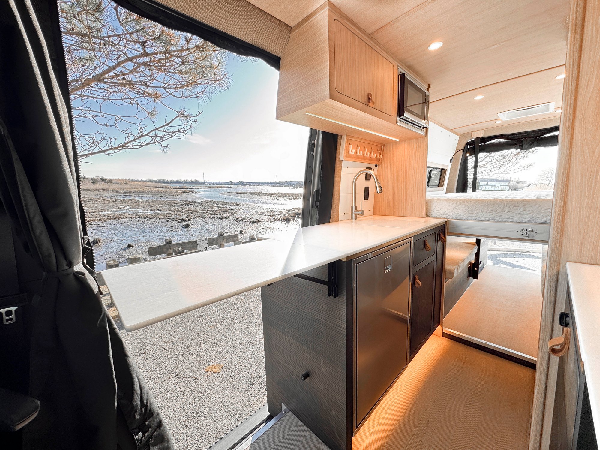 The Loft — galley with the white solid-surface counter extension flipped up over the aisle, marina view