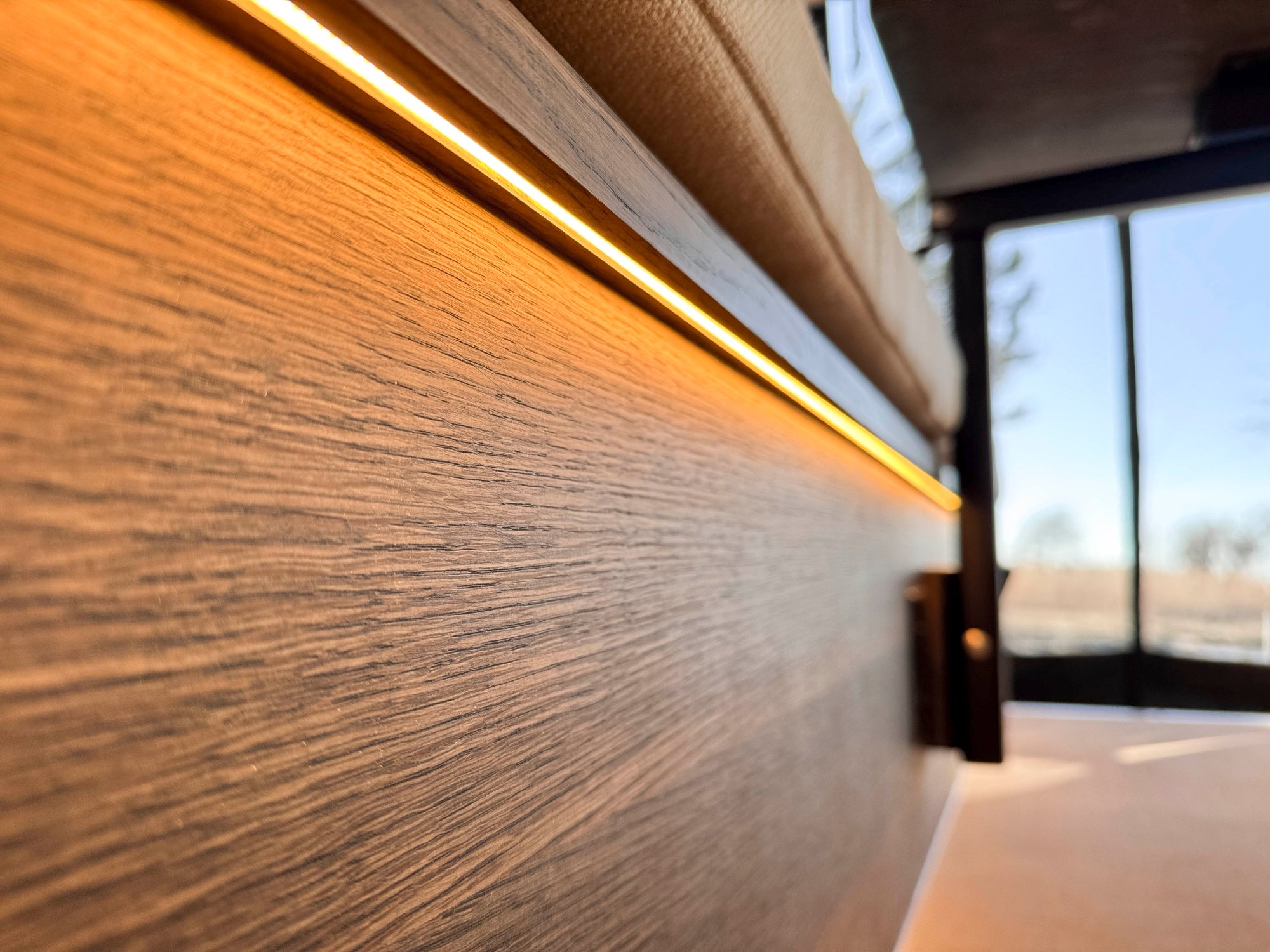 The Loft — wood-grain wall panel with recessed ambient LED lighting