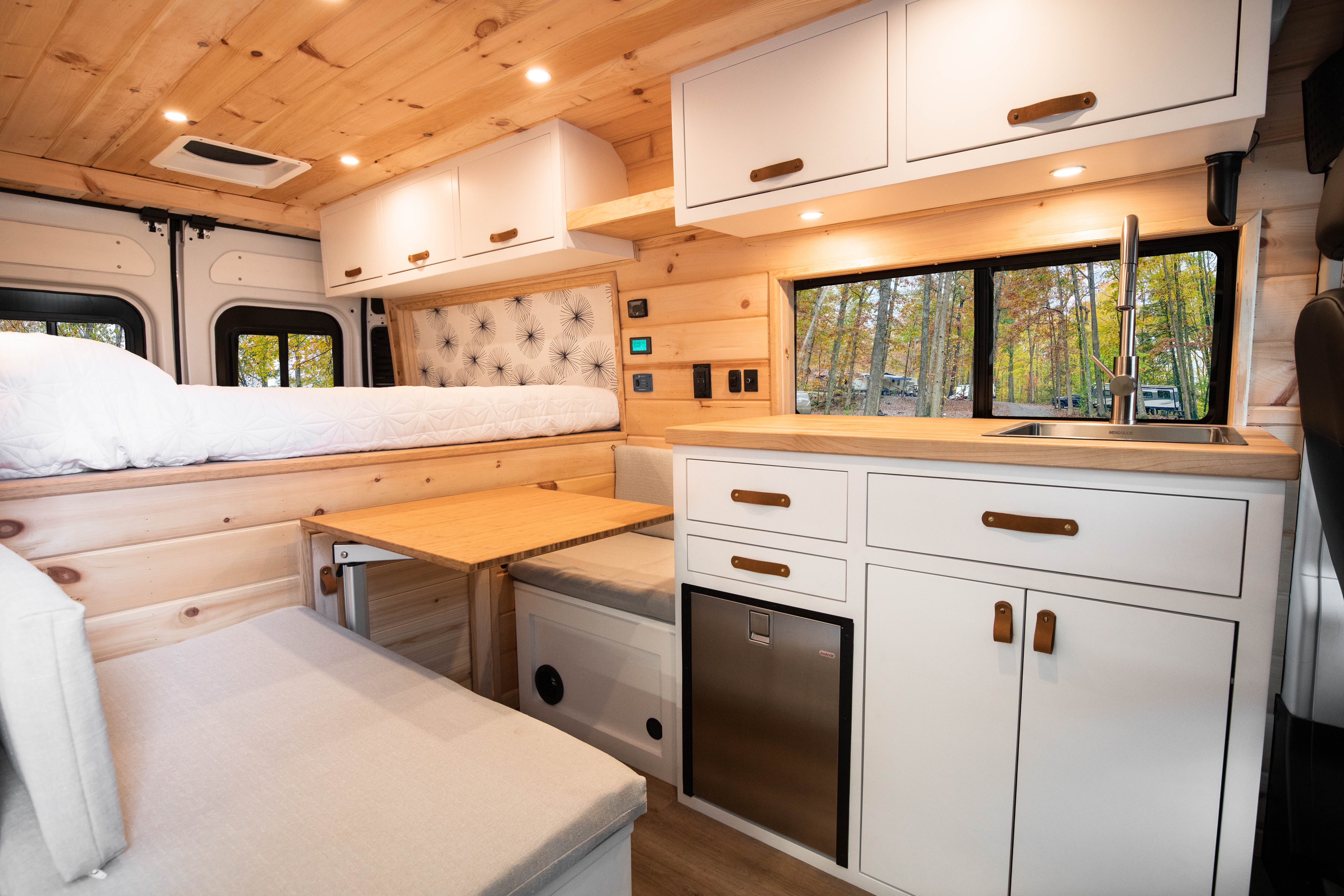 Raritan — Ram ProMaster 159, pine-and-white galley and rear lounge interior