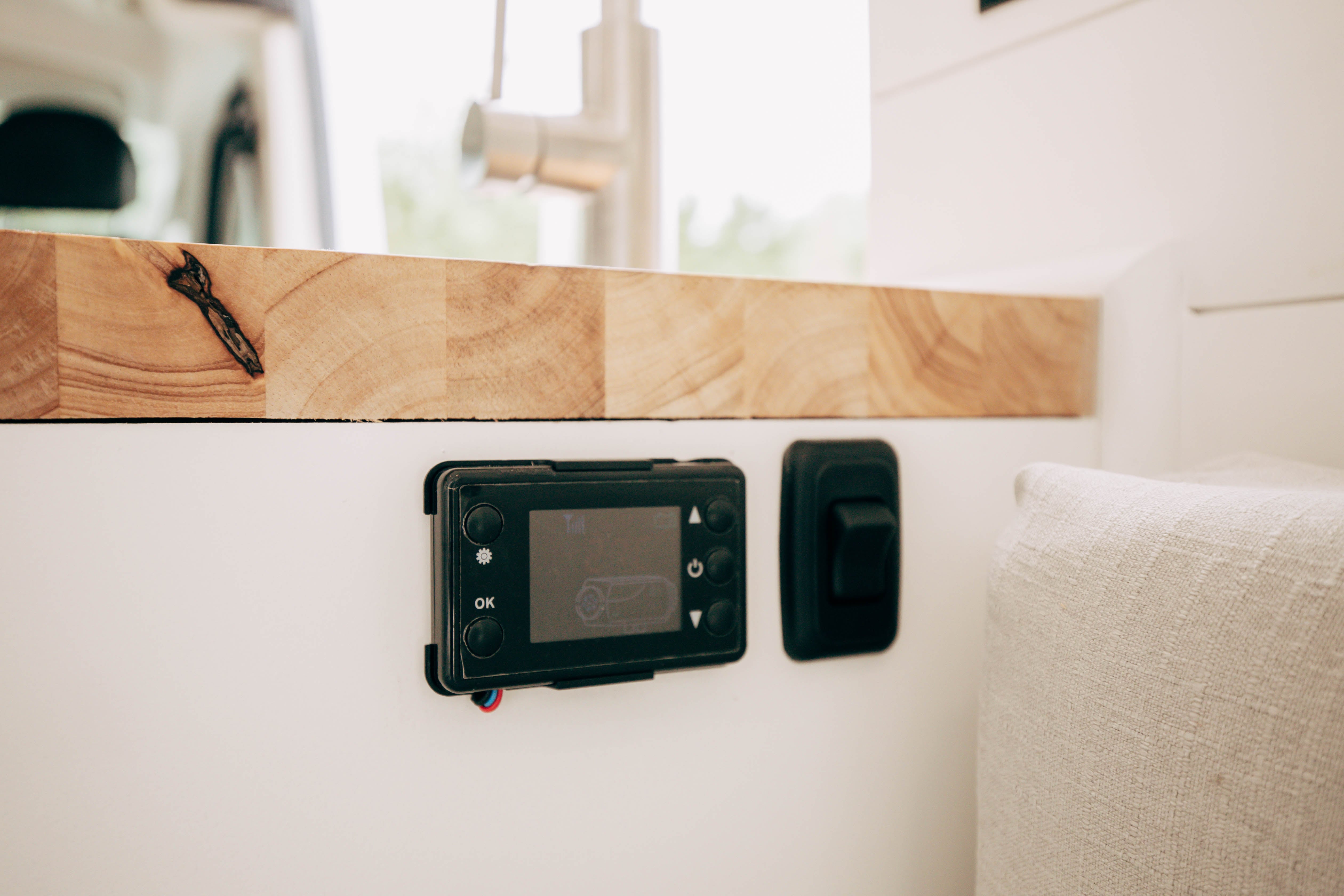 Riverside ProMaster 159 campervan wall-mounted control panel on a wood shelf