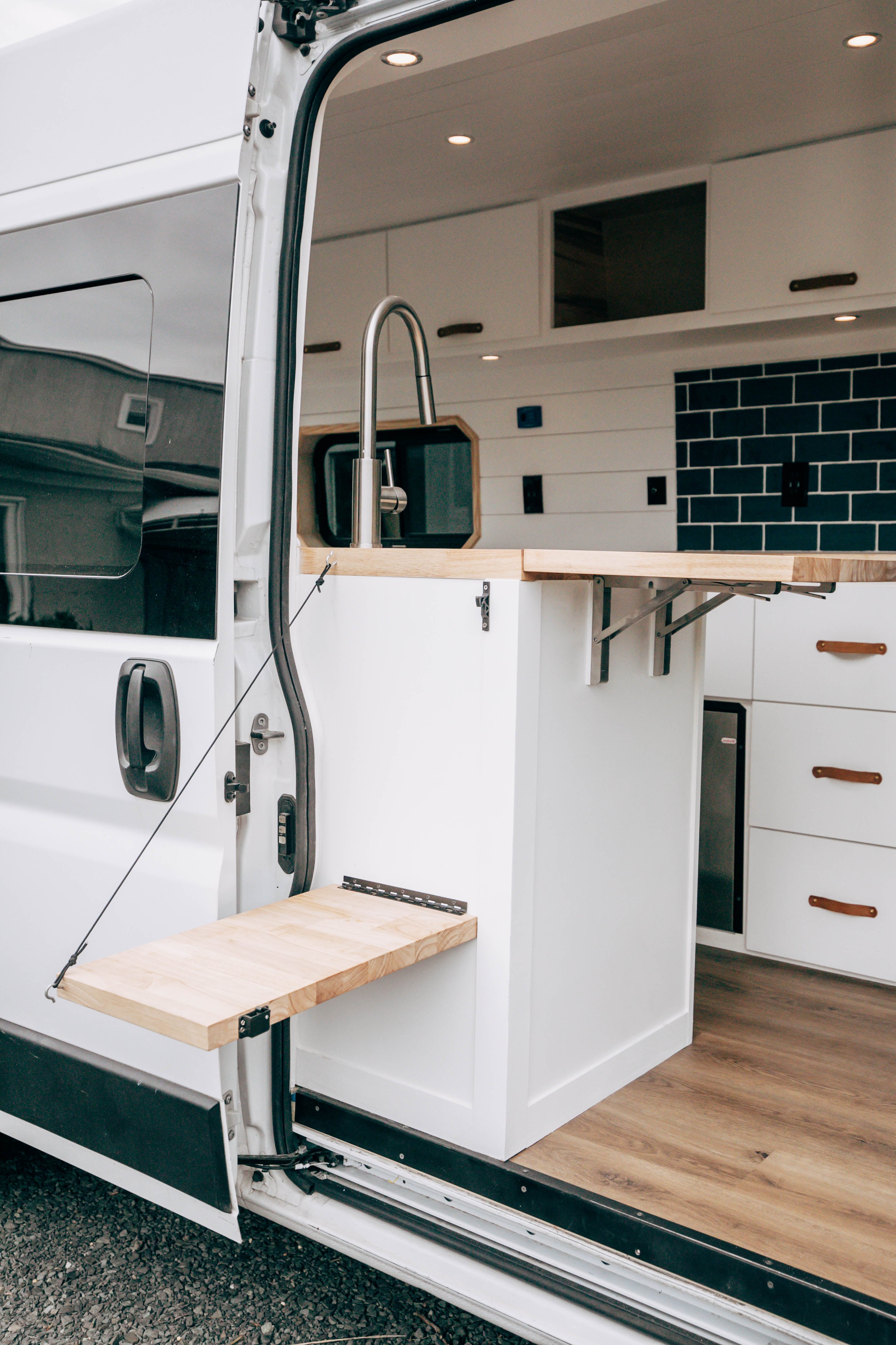 Riverside ProMaster 159 campervan rear doors open showing the galley and entry step
