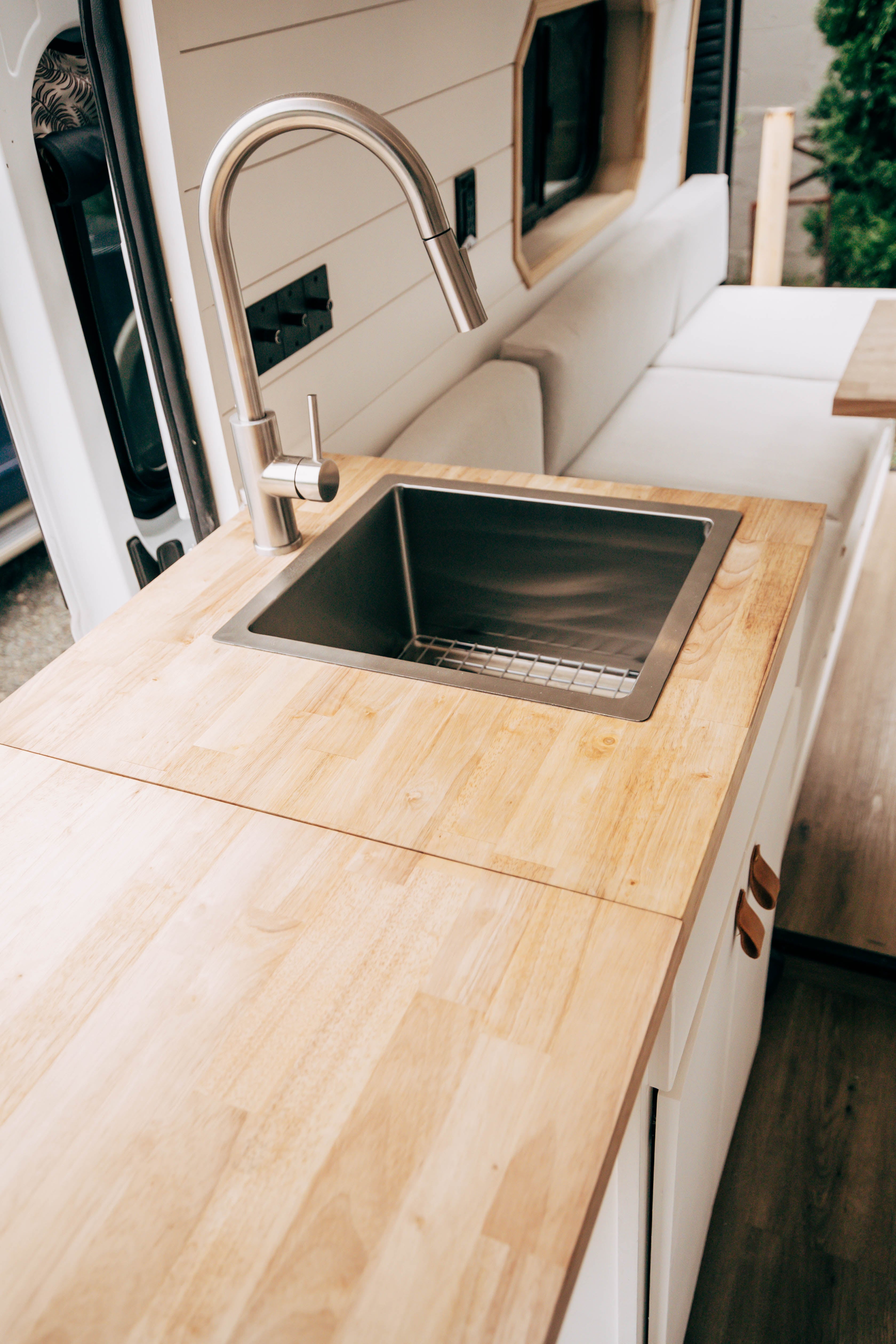 Riverside ProMaster 159 campervan galley counter and sink from the side with wood cabinet fronts