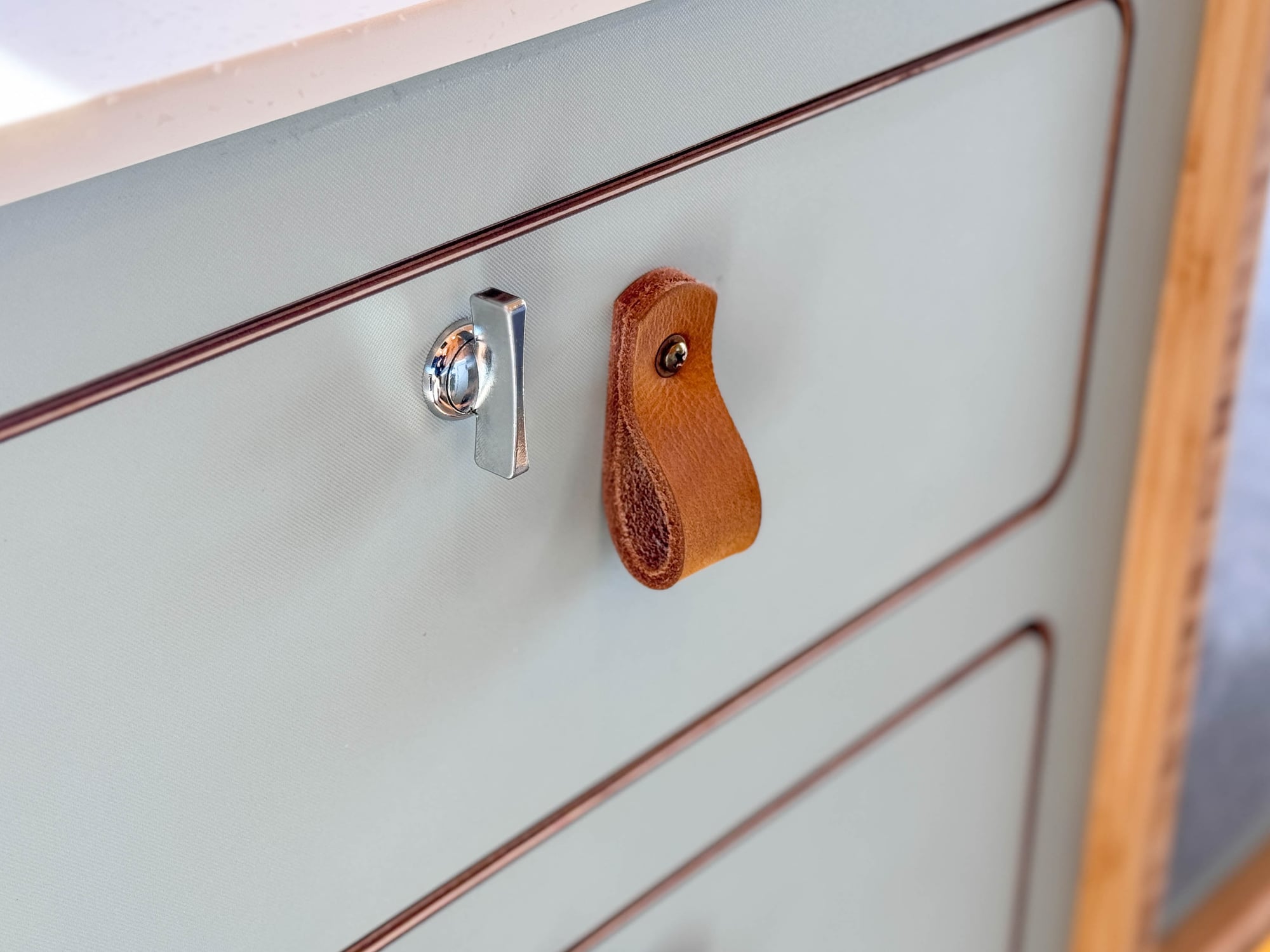 The Scout — sage cabinet doors with leather pulls