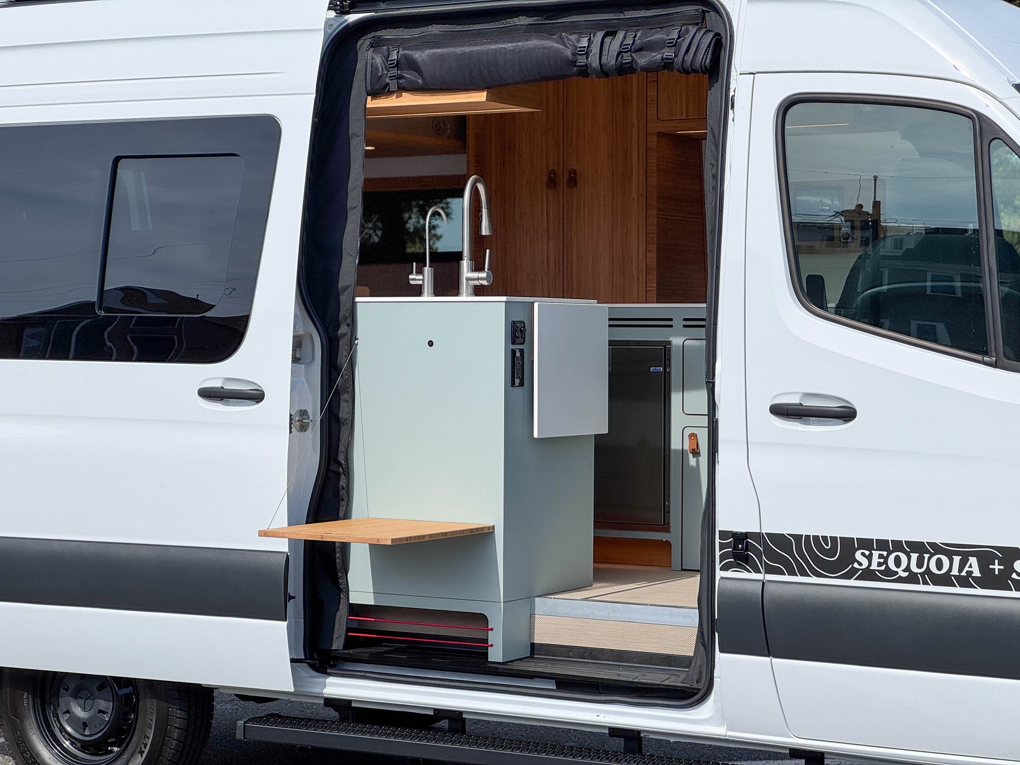 The Scout — grey Sprinter 144 with the sliding door open to the galley