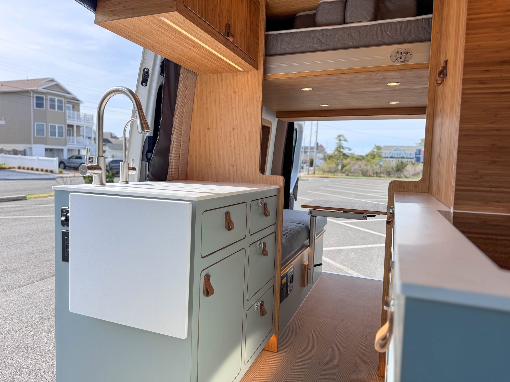 The Scout galley from the rear — sage cabinetry and bamboo counter