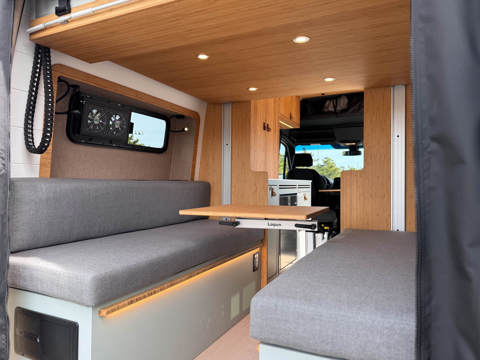 The Scout — convertible lounge with bamboo table deployed, lift bed raised above