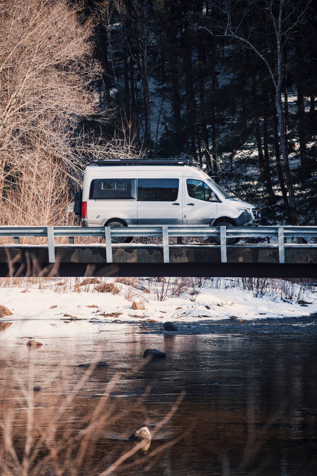 The Stoke — silver Sprinter 144 crossing a bridge over a winter river
