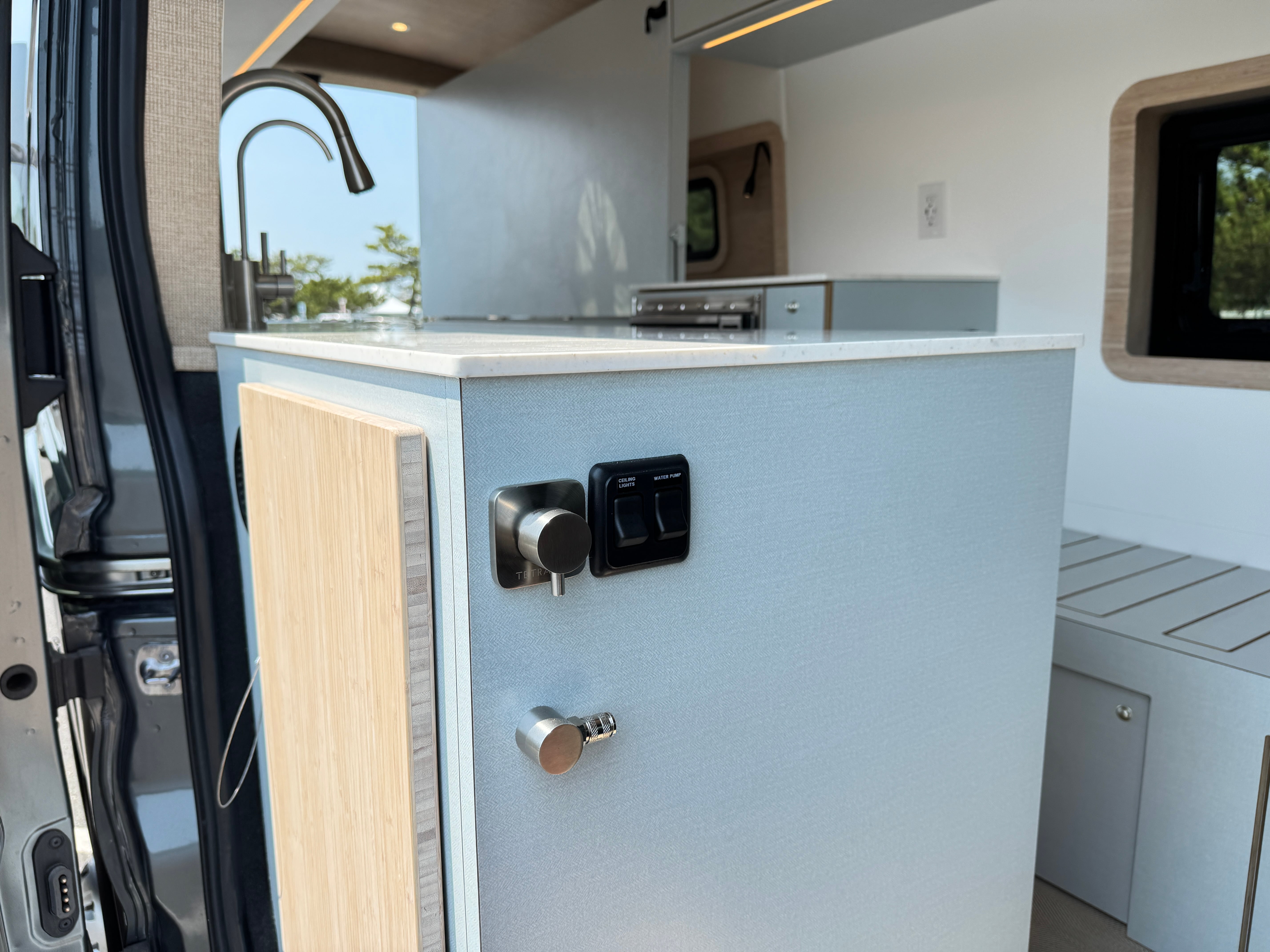 Super Lounger Ford Transit galley cabinet and sink with a black faucet