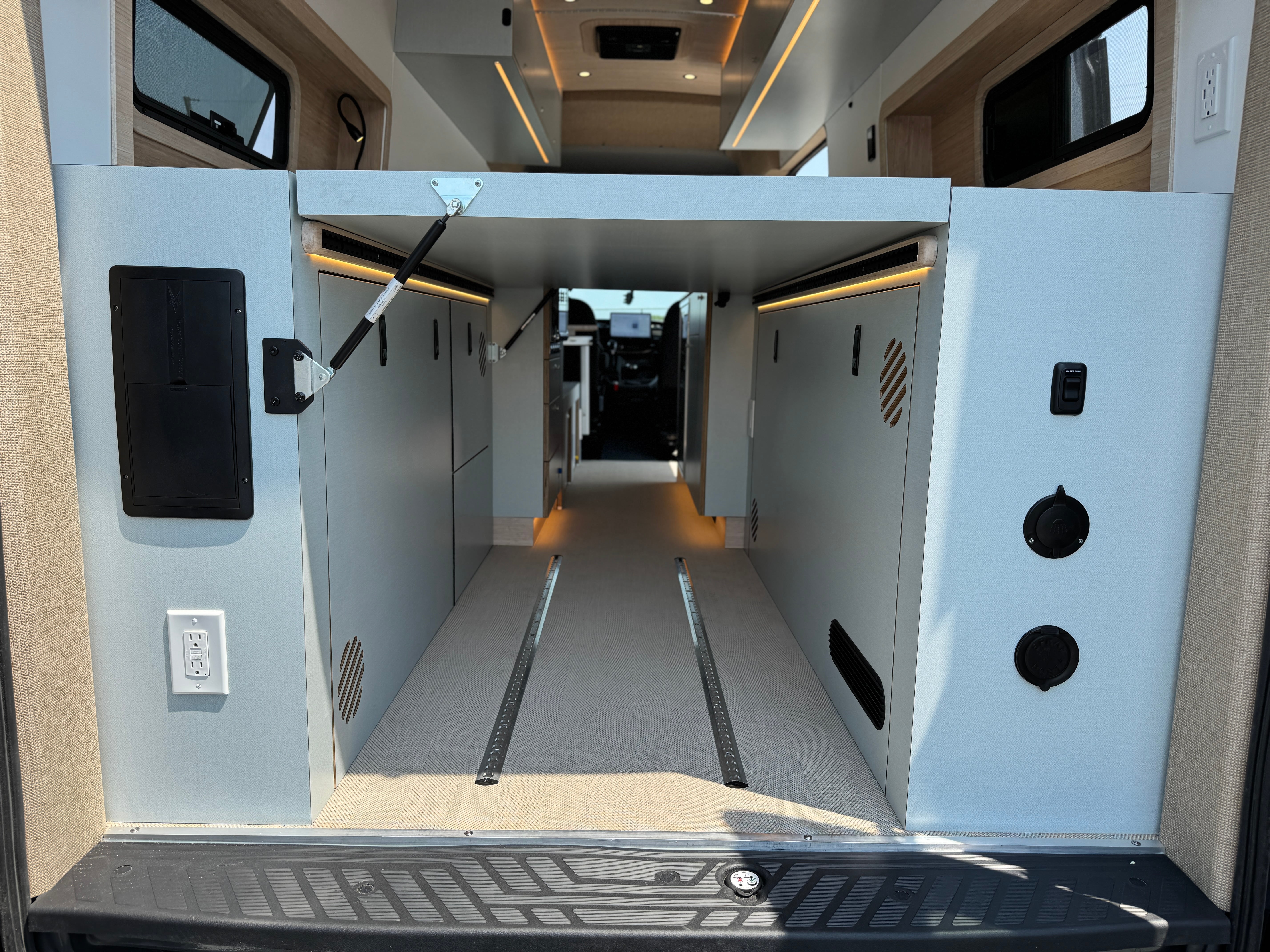 Super Lounger Ford Transit rear cabin with facing benches and ambient lighting