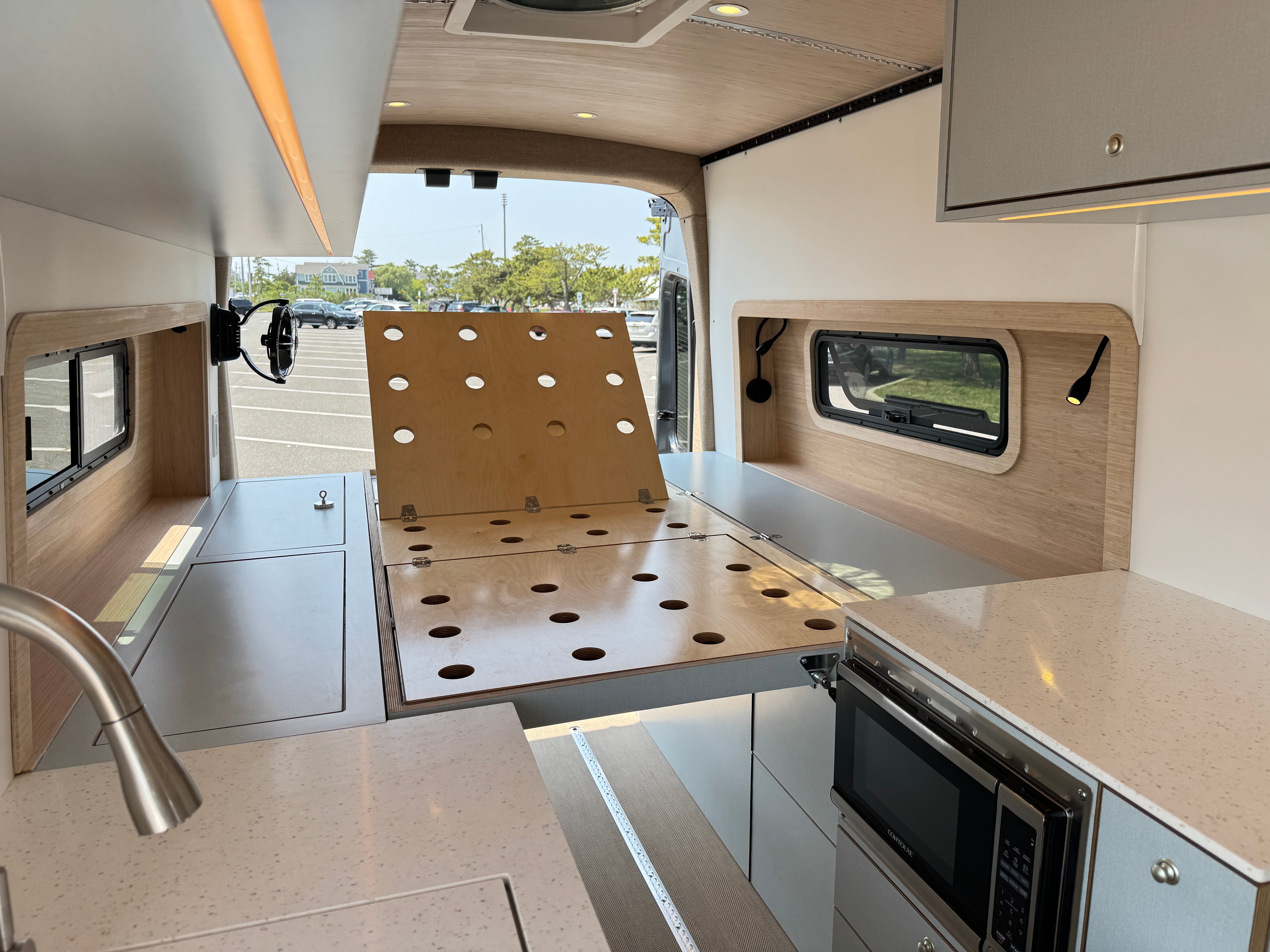 Super Lounger Ford Transit convertible lounge platform staged beside the galley counter