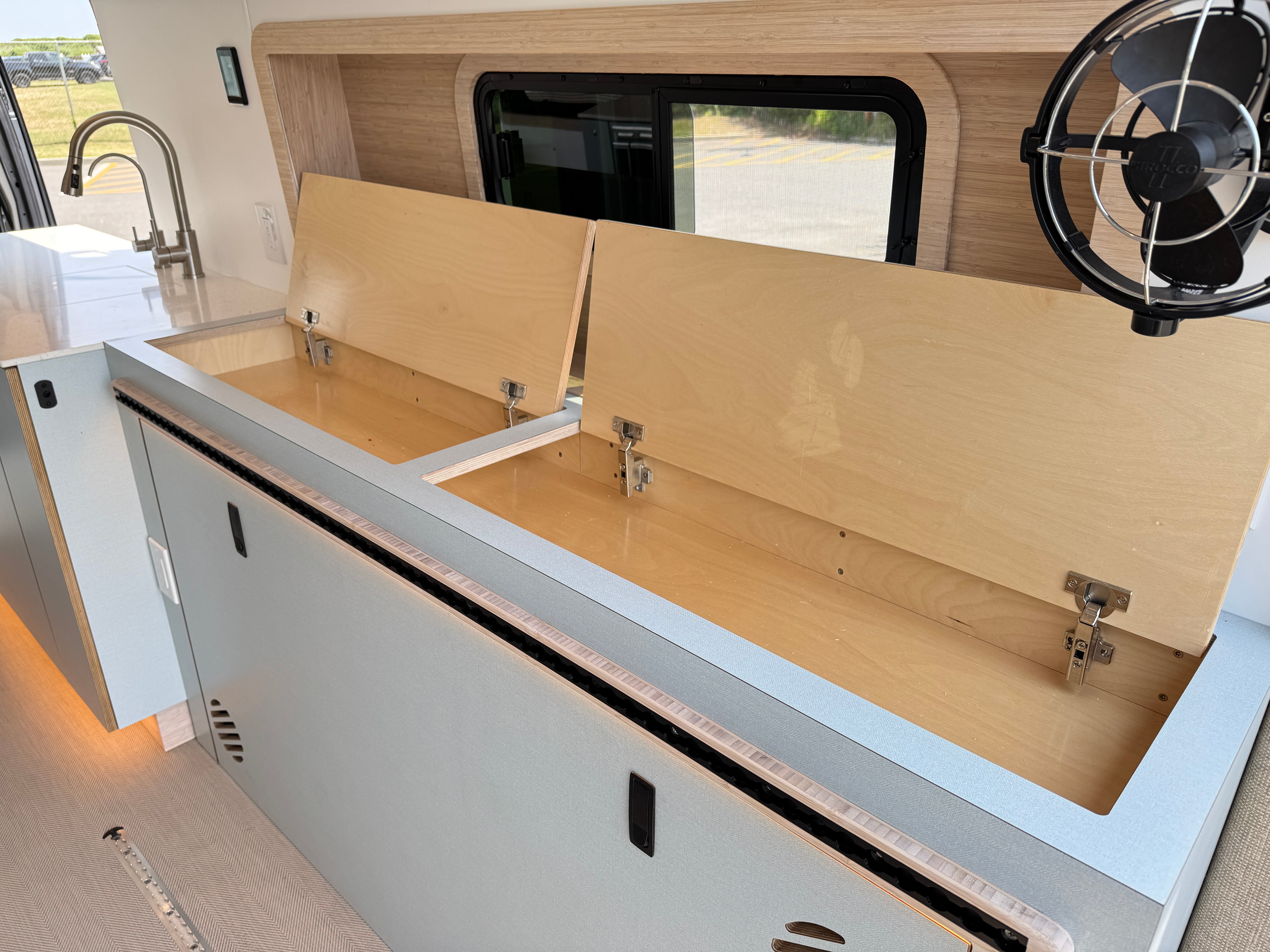 Super Lounger Ford Transit bench seat lifted open on gas struts revealing storage