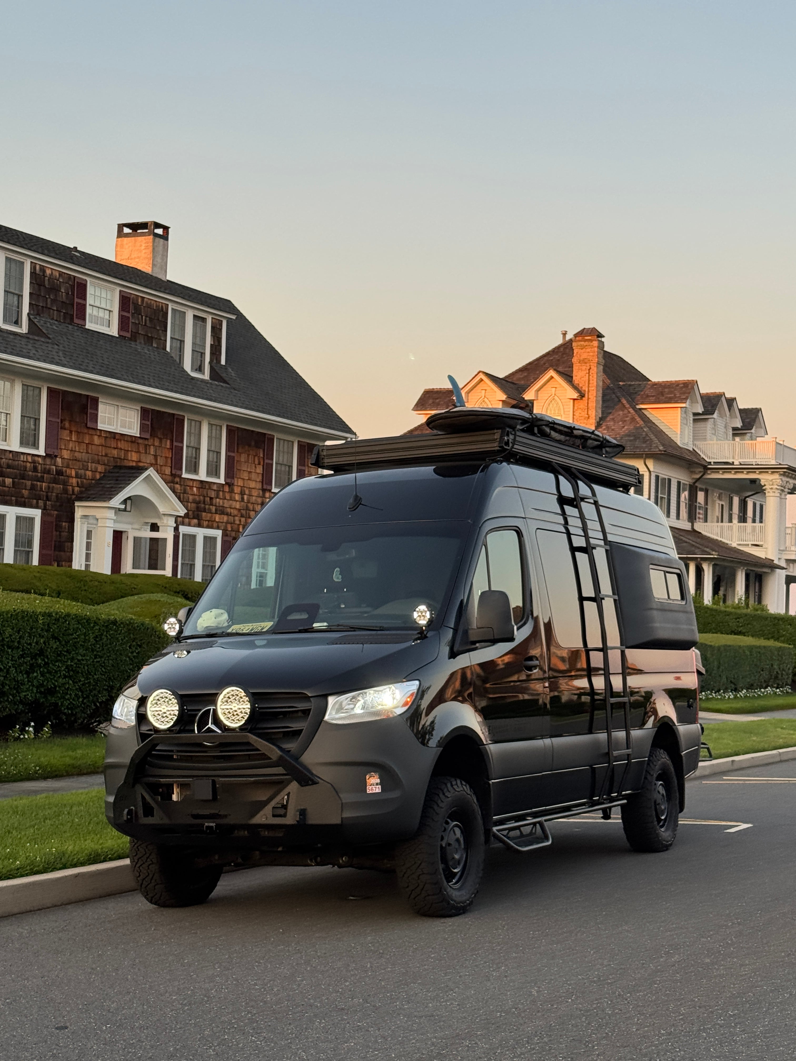 The Don Sprinter 144 campervan front exterior with off-road bumper and roof rack at dusk