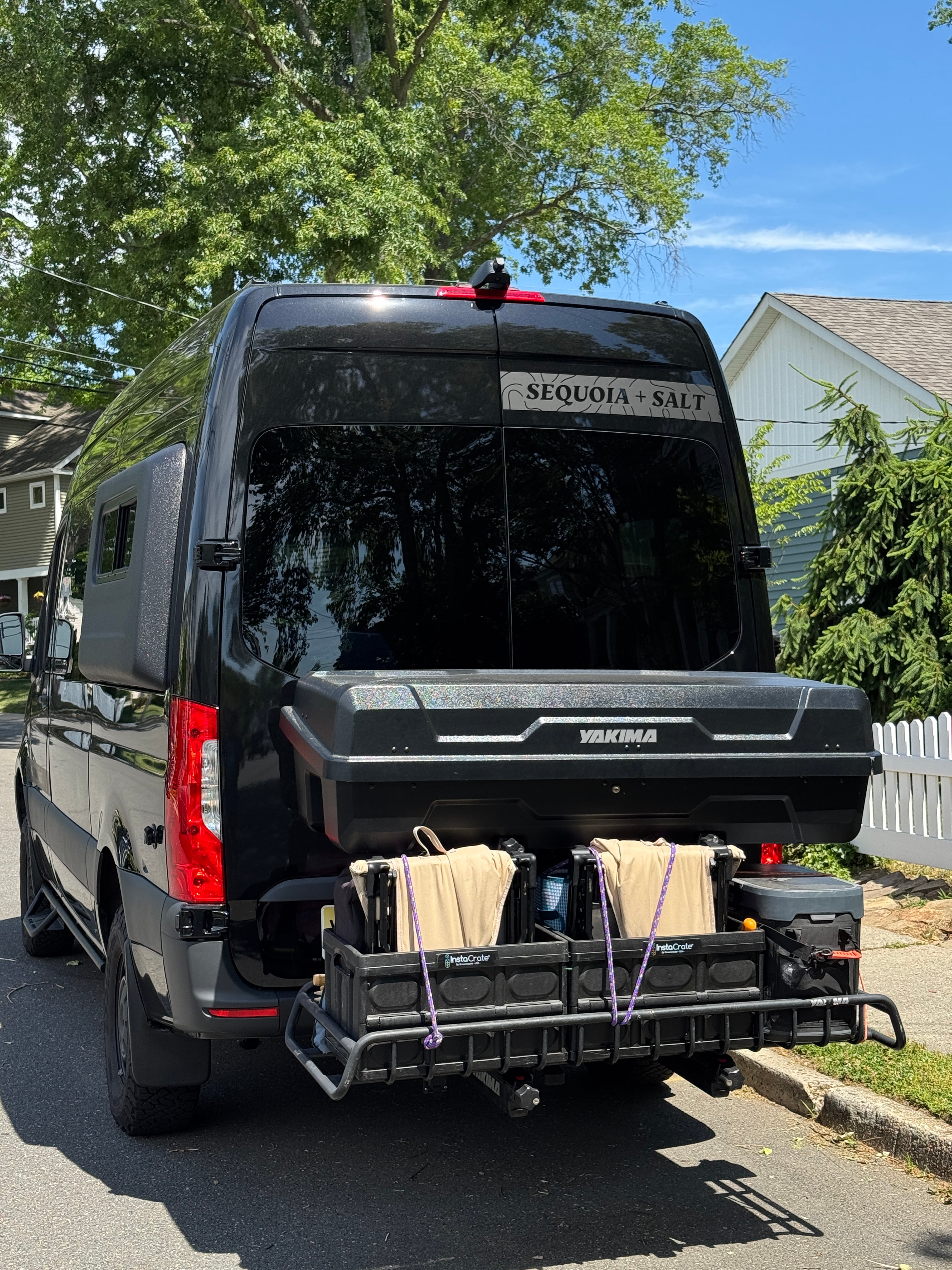 The Don Sprinter 144 campervan rear exterior with a bike rack in a driveway