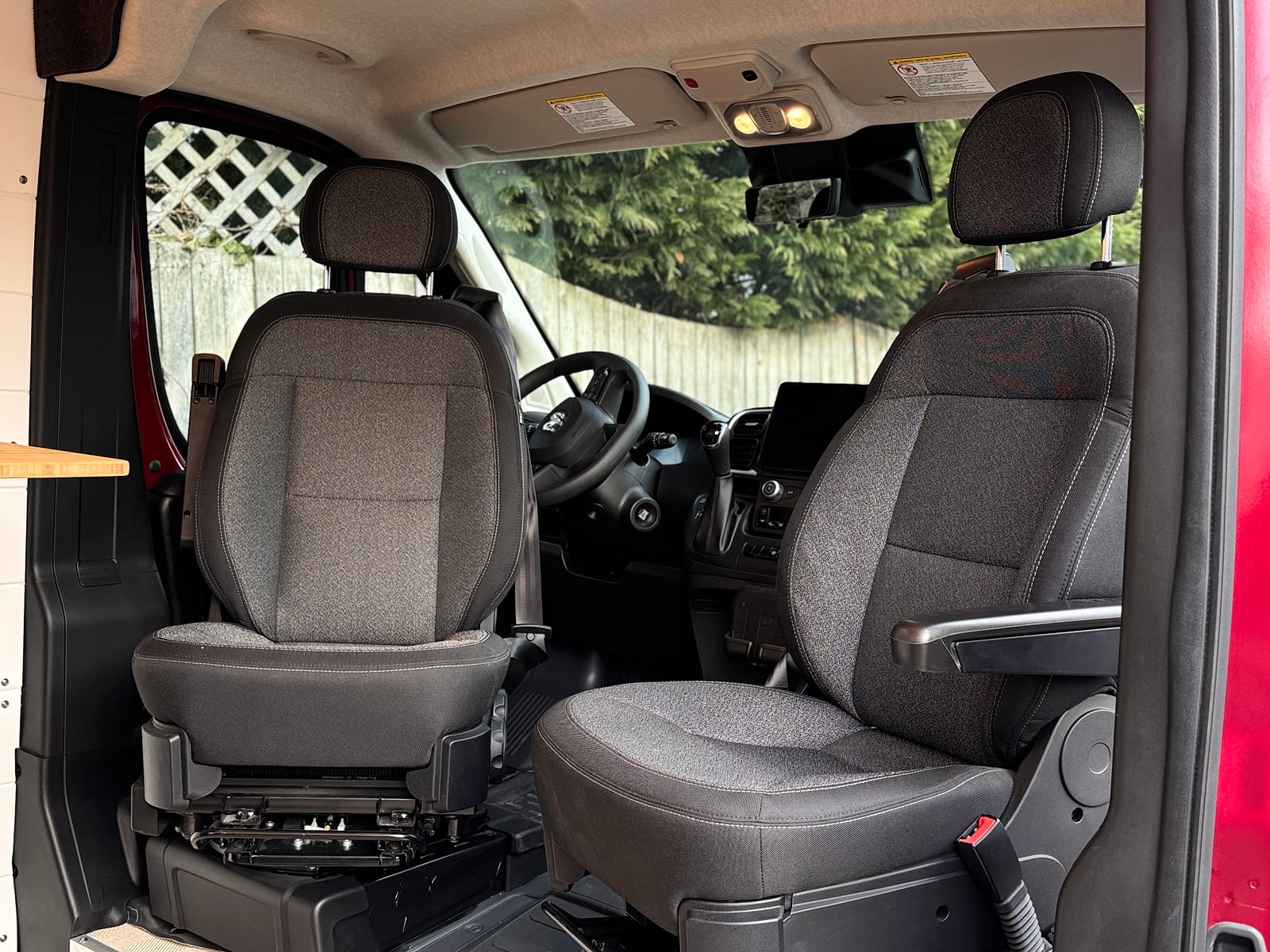 Bobal Mobile Salon — swivel cab seats and open floor area by the side door of the ProMaster mobile salon