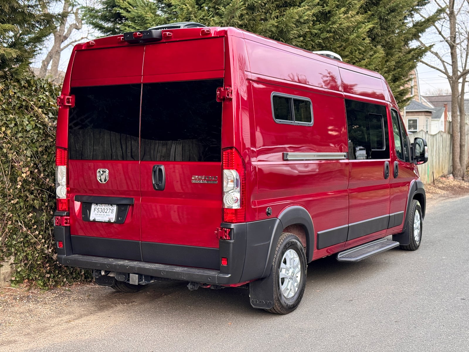 Bobal Mobile Salon — red ProMaster 159 high-roof, rear three-quarter exterior, ready to travel to a client