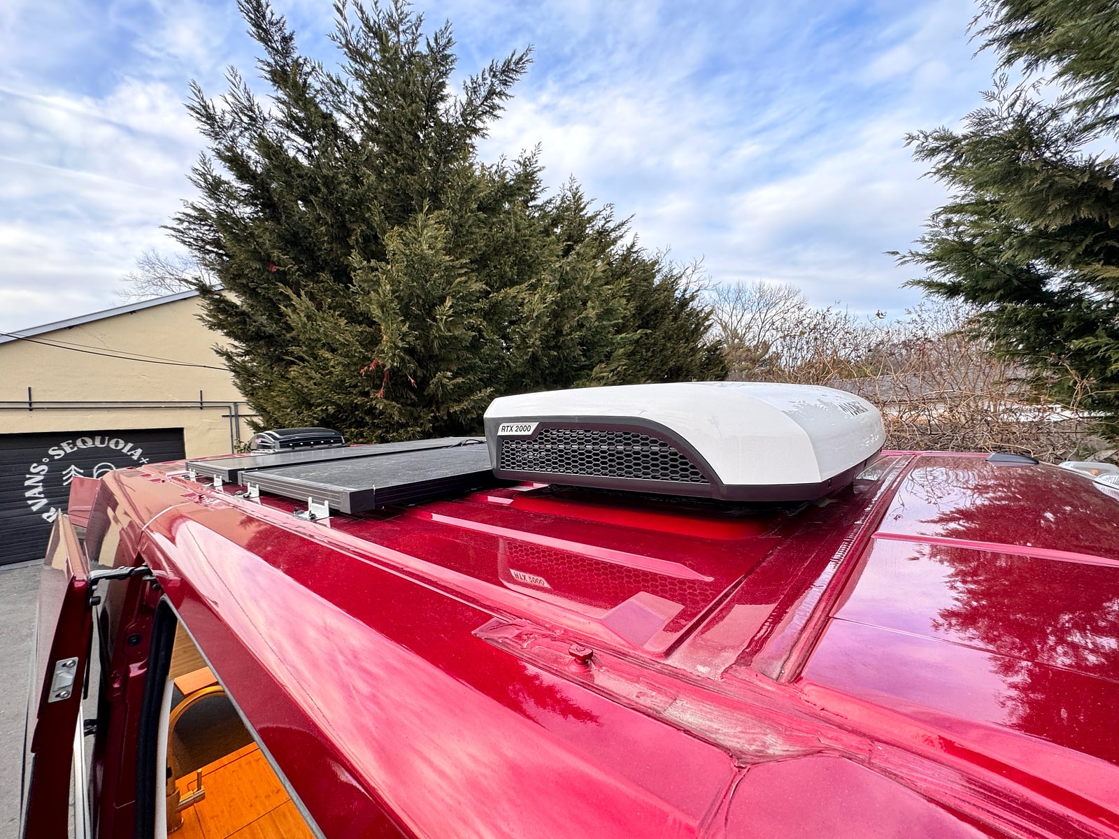 Bobal Mobile Salon — roof-mounted solar panel and air conditioner on the red ProMaster