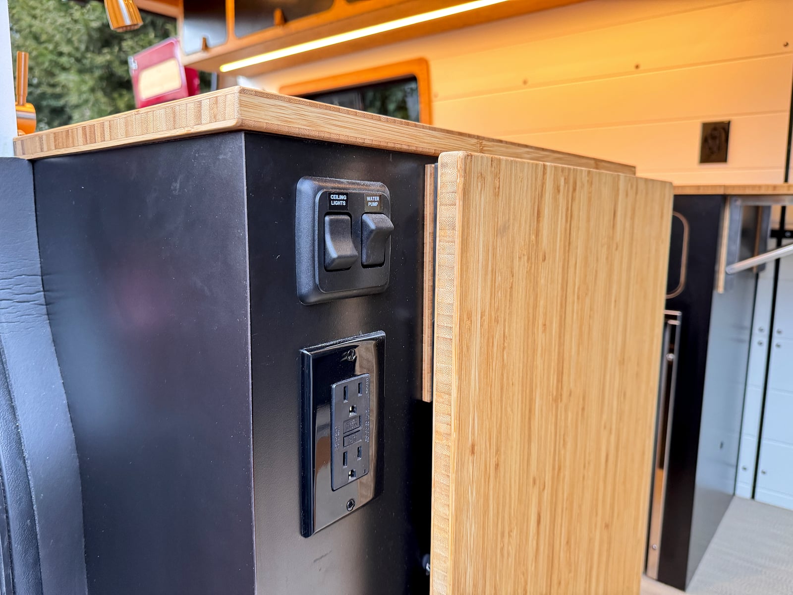 Bobal Mobile Salon — galley-side power port and switch panel for hair-styling tools and sewing equipment