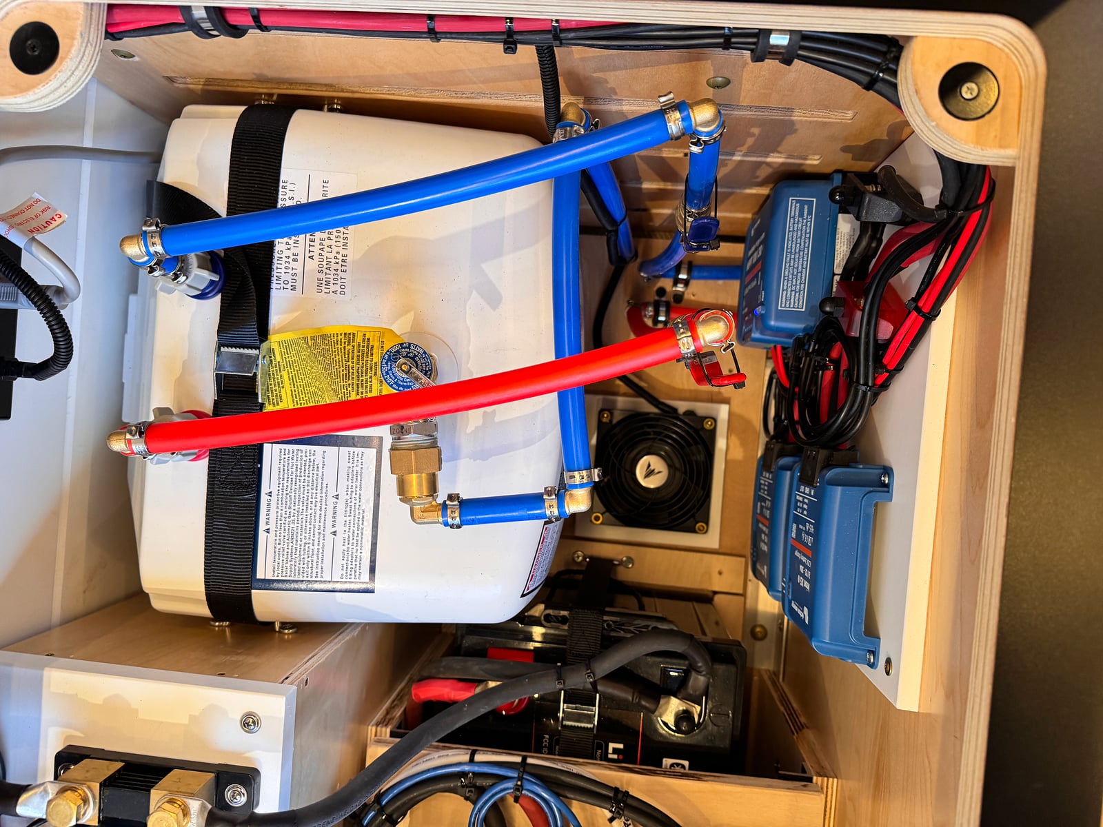 Bobal Mobile Salon — tankless water heater with hot and cold PEX lines in the utility bay