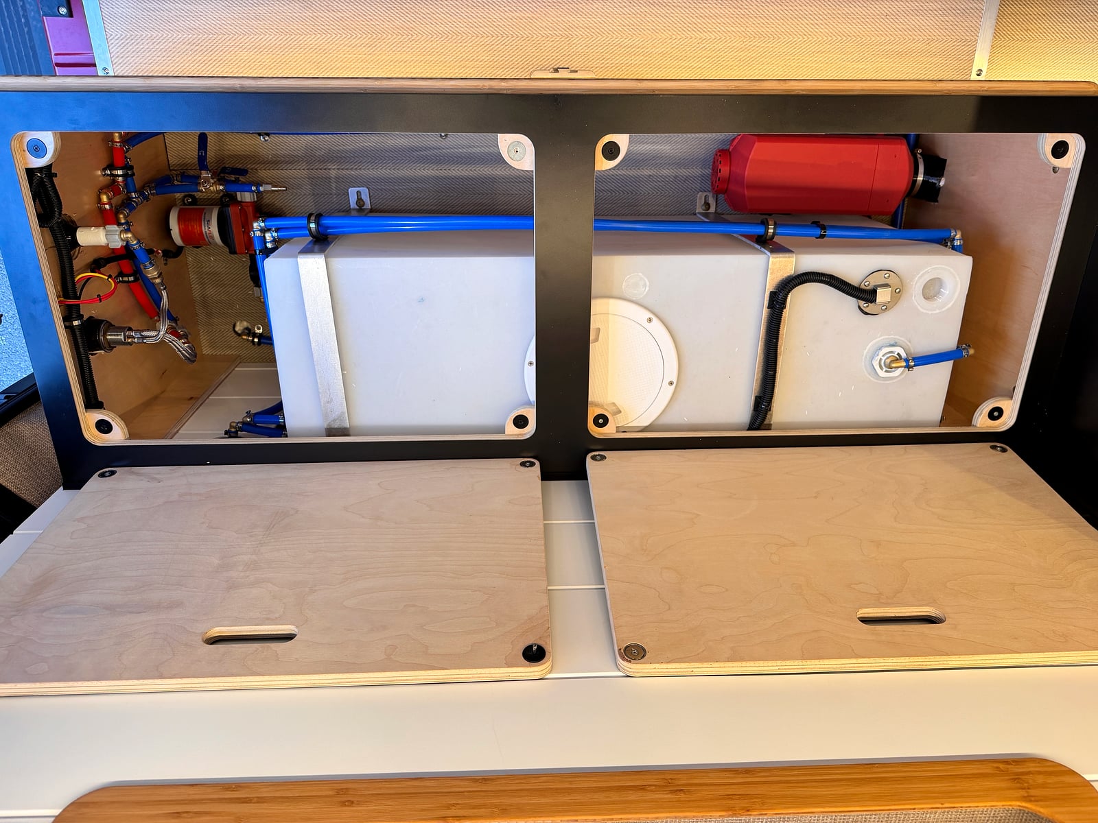 Bobal Mobile Salon — onboard fresh-water tank, pump, and PEX plumbing in an access bay