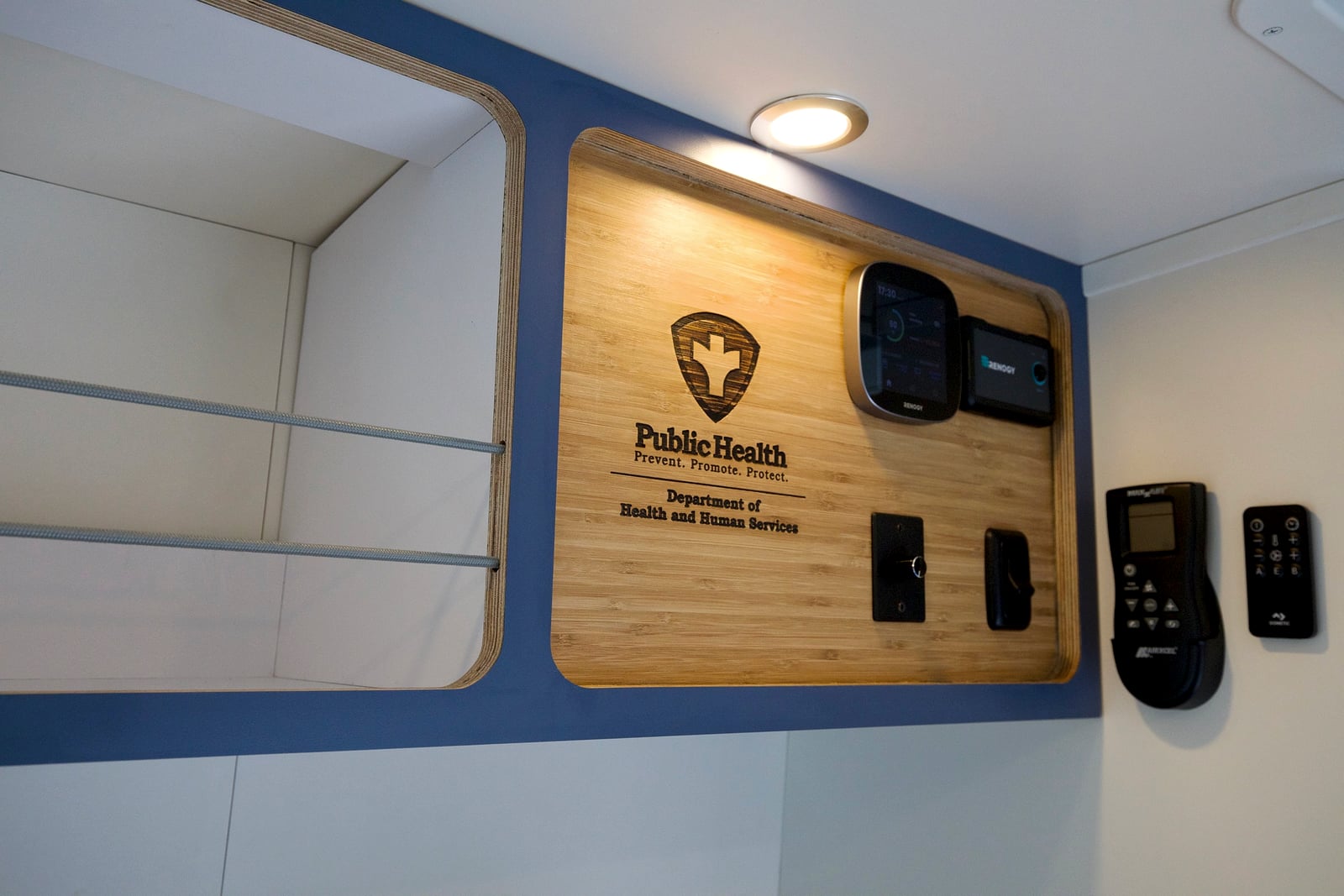 Northampton DCC electric Transit fleet — laser-engraved bamboo control panel with the Department of Health and Human Services Public Health mark