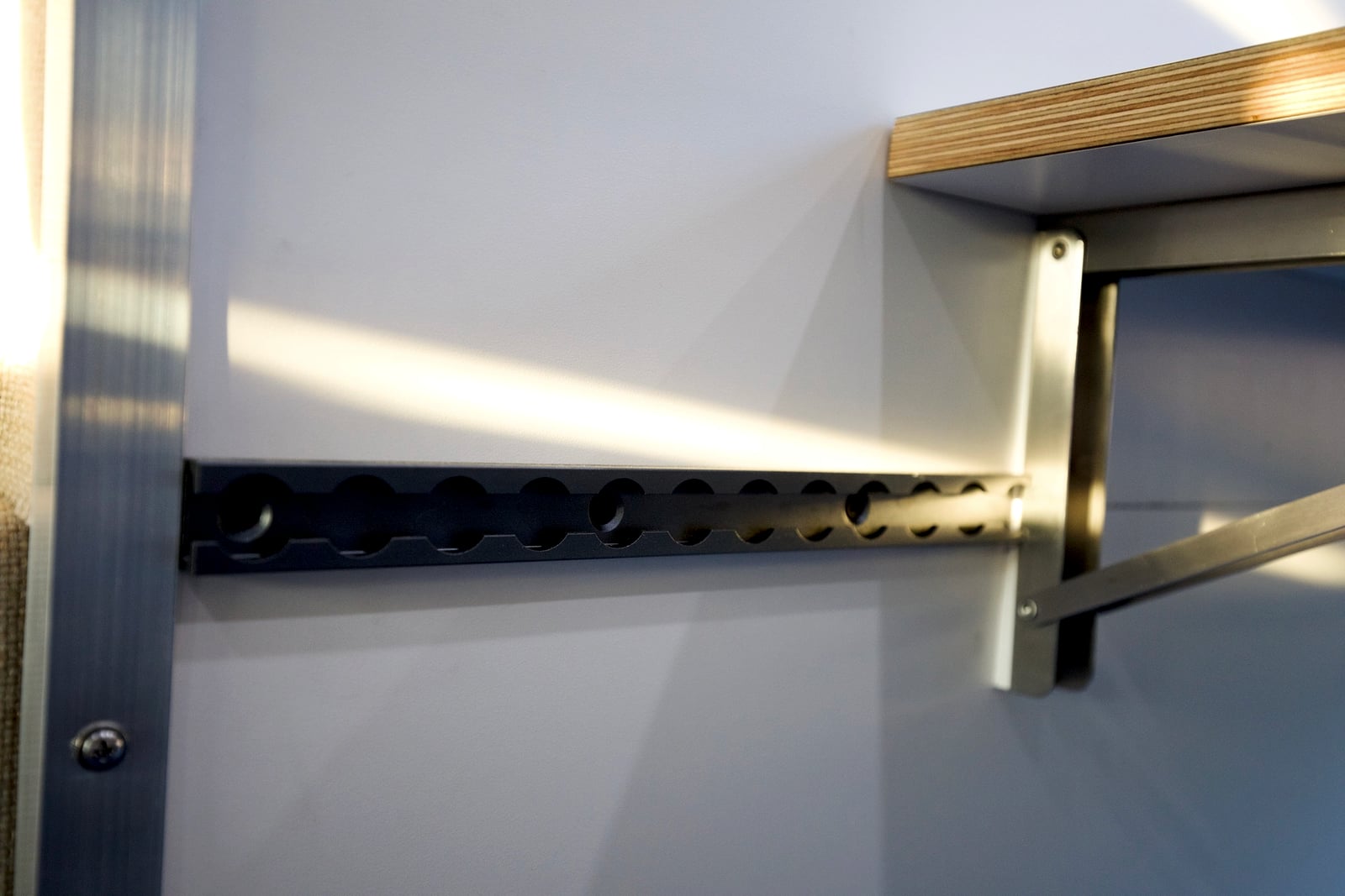 Northampton DCC electric Transit fleet — modular slotted wall track with aluminum brackets and baltic-birch shelving
