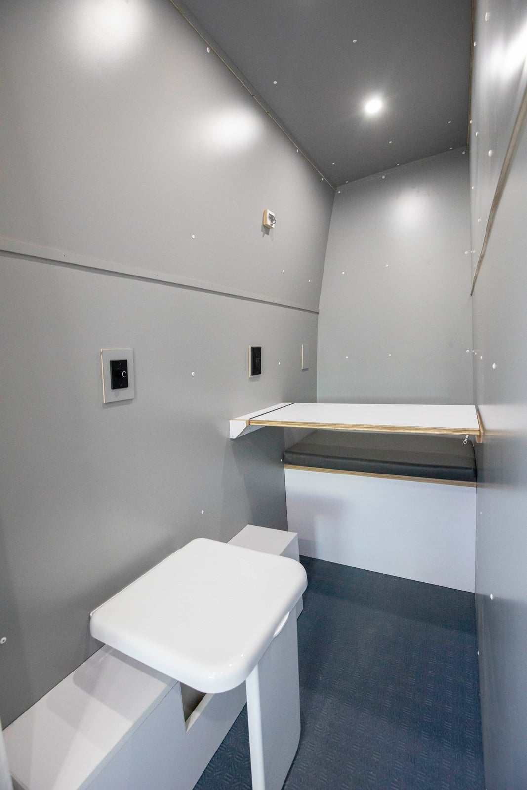 PROCEED Mobile Testing Van — enclosed wet bath with cassette toilet and fold-down shower bench