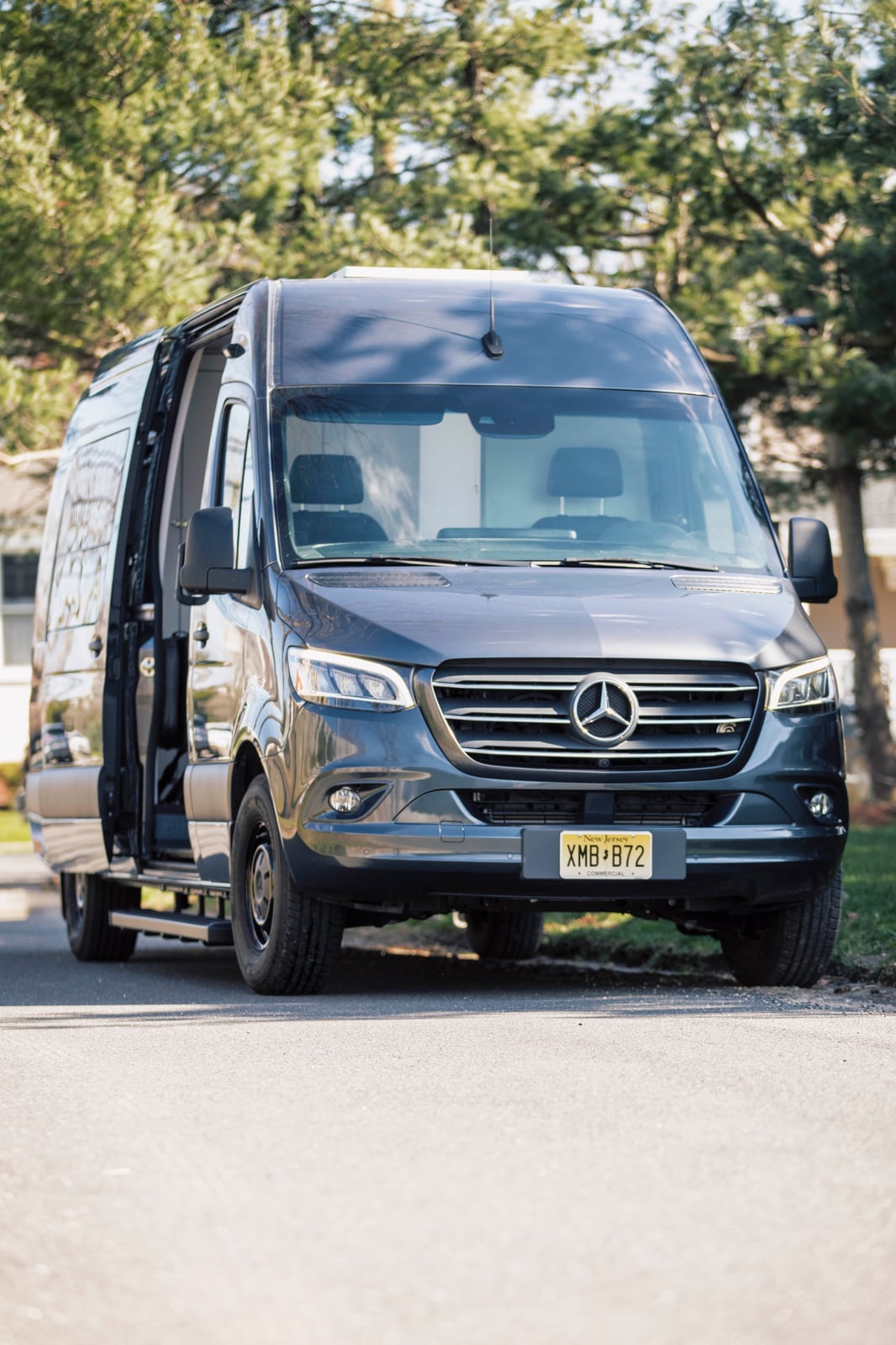 PROCEED Mobile Testing Van — graphite-grey Sprinter parked with sliding door open, ready to receive clients
