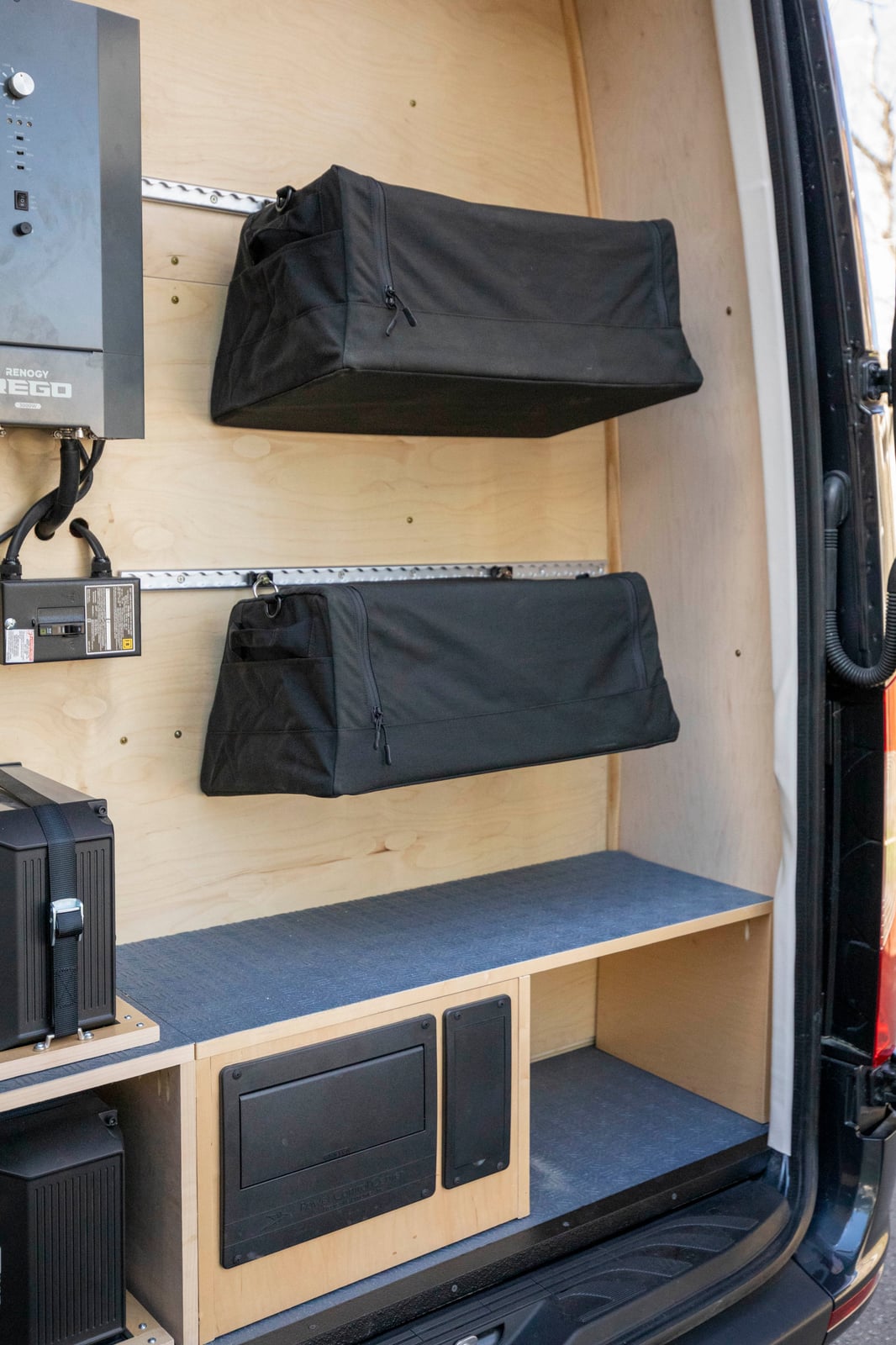PROCEED Mobile Testing Van — rear gear garage with track-wall soft storage bags on baltic birch