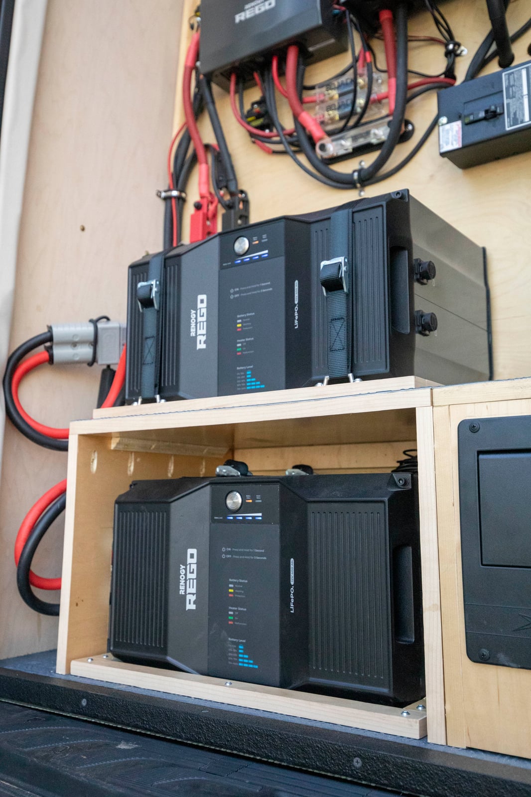 Sprinter mobile testing van — dual LiFePO4 lithium batteries wired into the baltic-birch battery bay