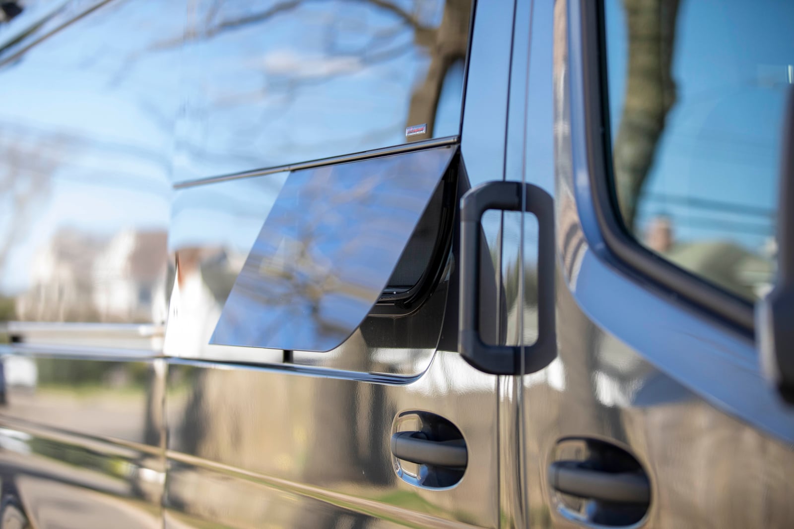 Sprinter mobile testing van — exterior cab vent window and door hardware detail