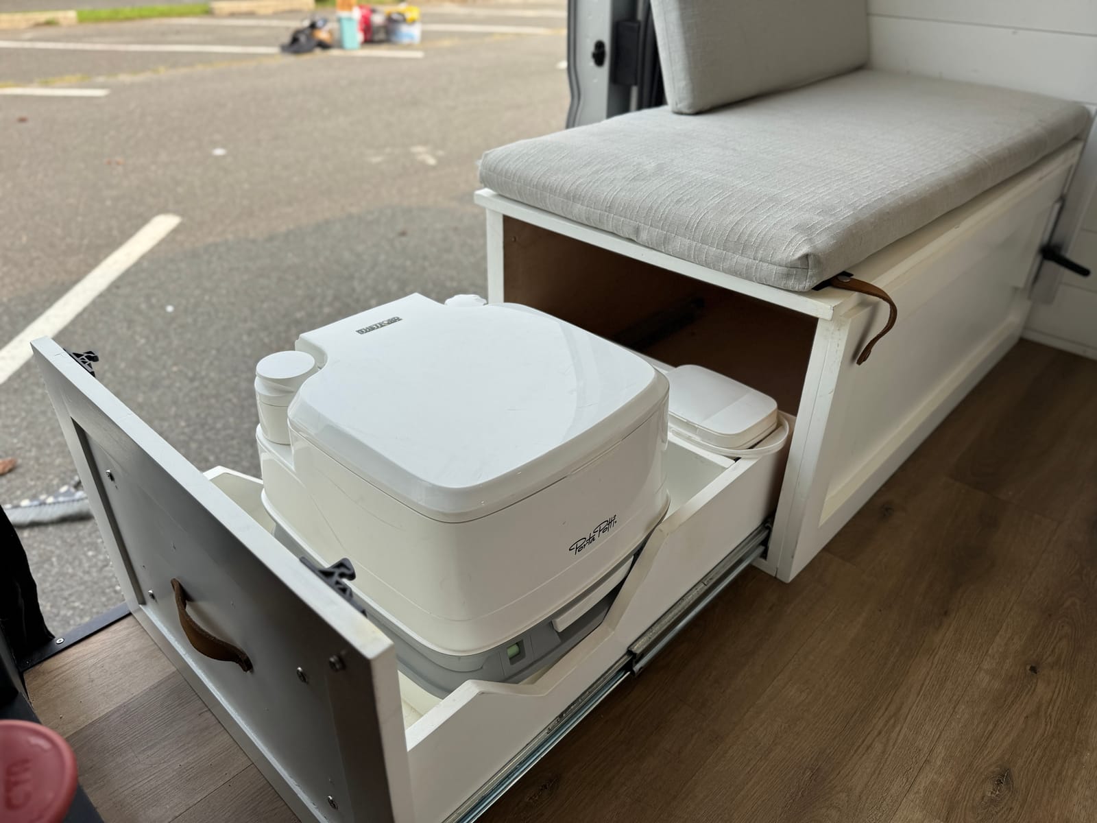 Slide-out cassette toilet deployed from its cabinet