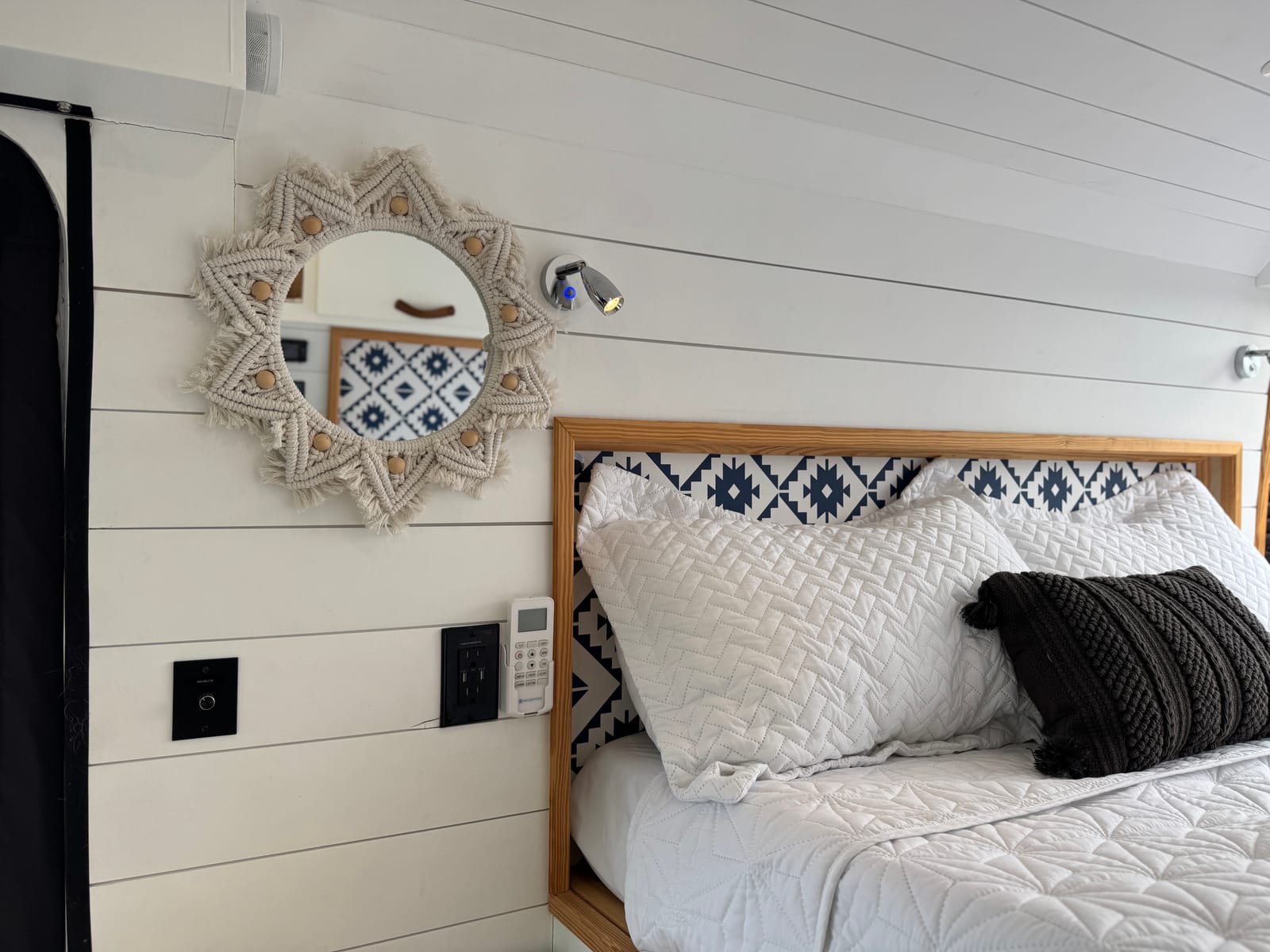 Bed headboard with a woven wall panel and mirror