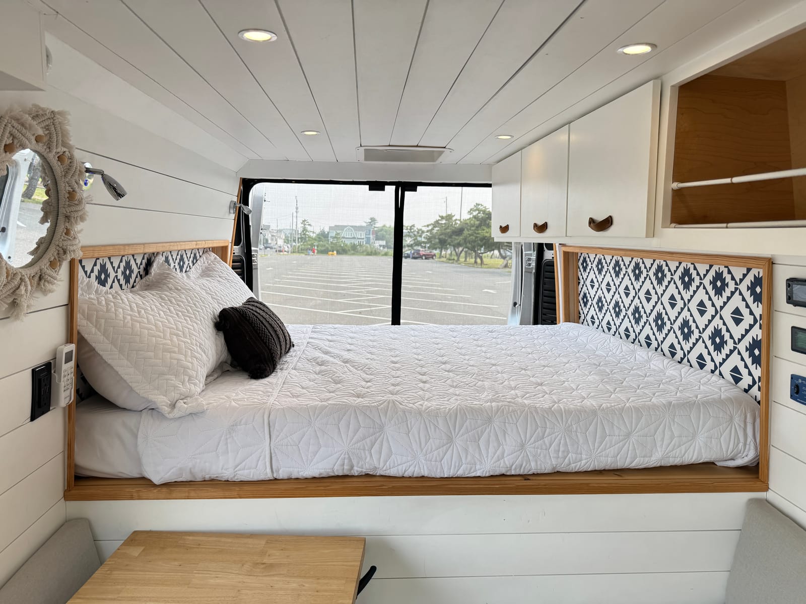 Rear bed with a side window and overhead cabinetry