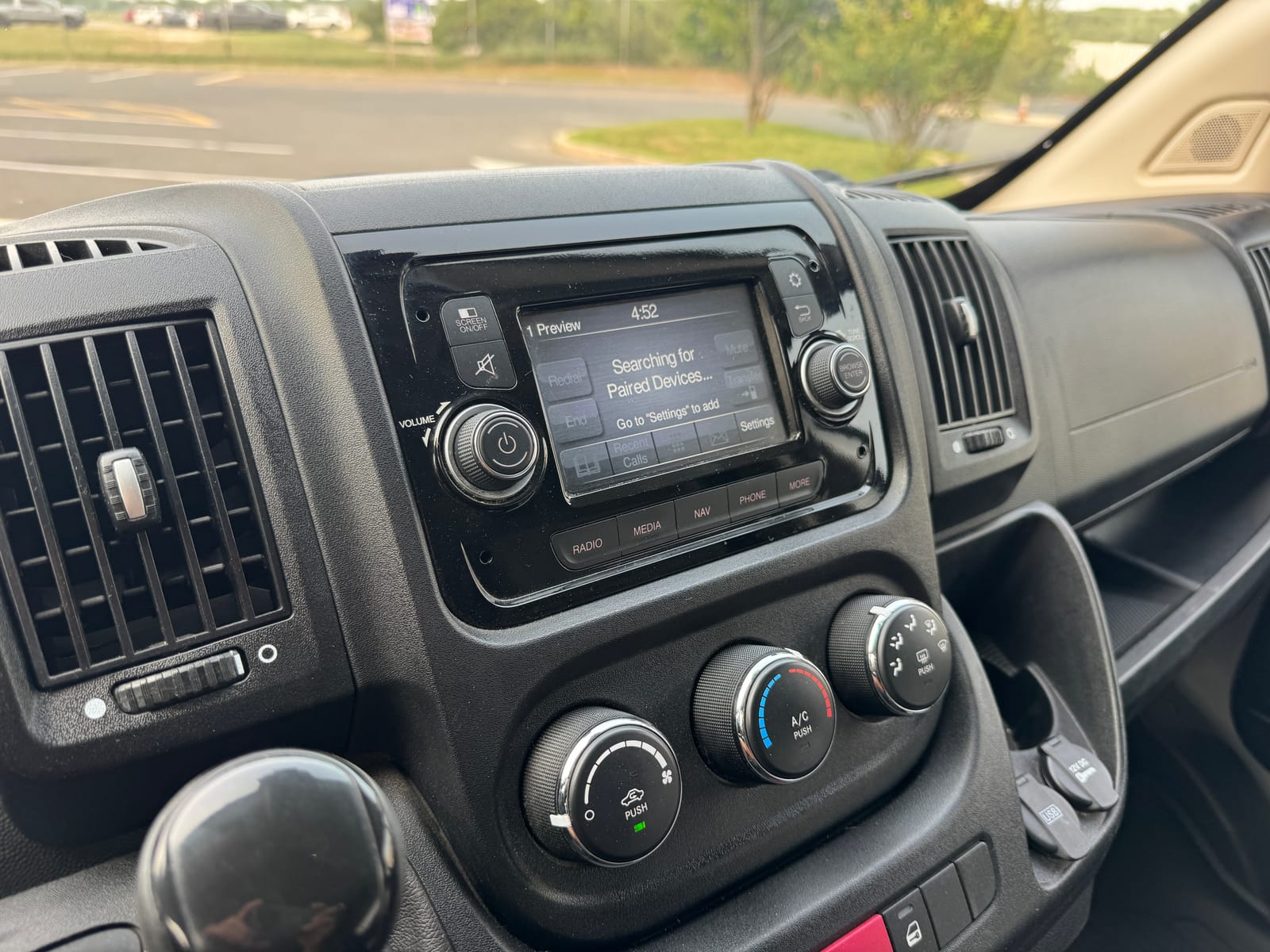 Center dash with the factory infotainment screen and climate controls