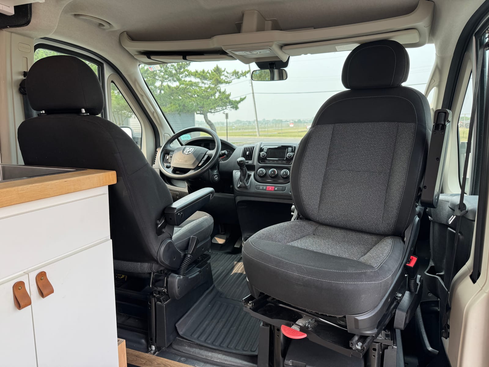 Cab with the passenger seat swivelled around toward the living space