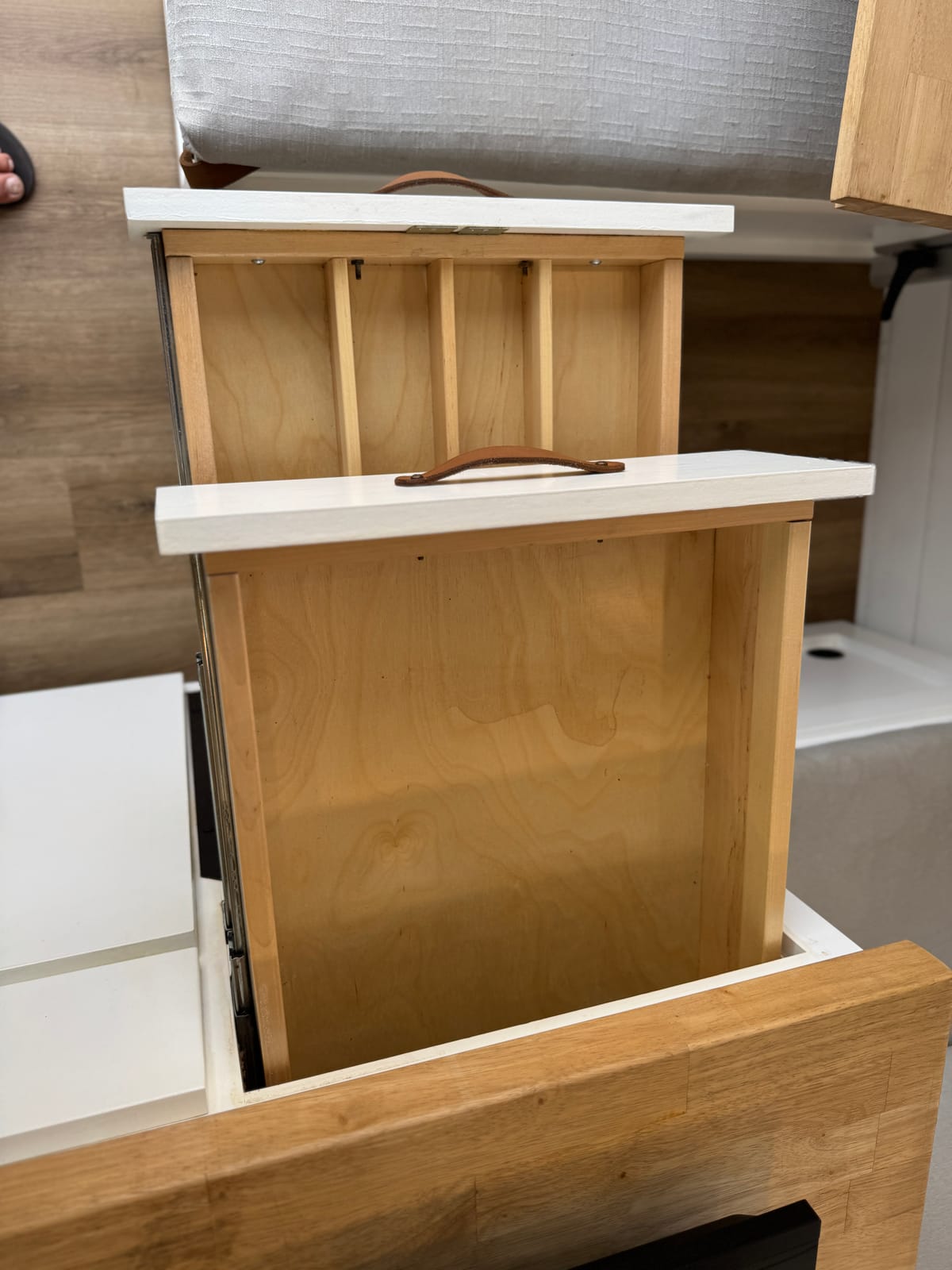 Cabinetry detail with a leather pull on a white cabinet face