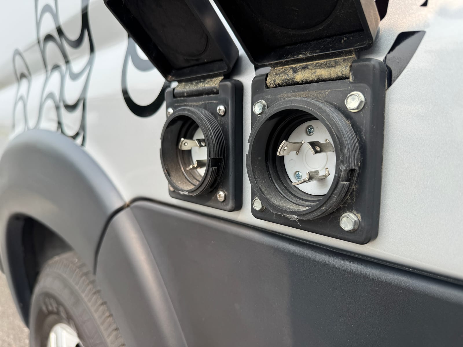 Exterior shore-power inlets on the rear body of the van