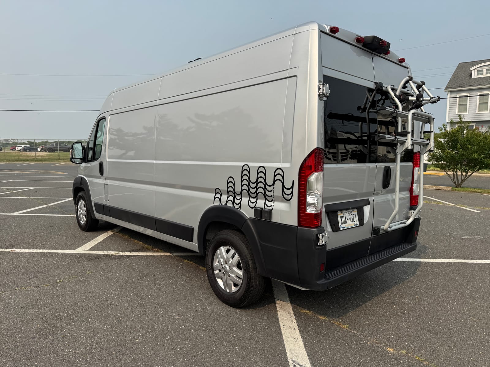 Driver-side profile with the rear Fiamma bike rack folded against the doors