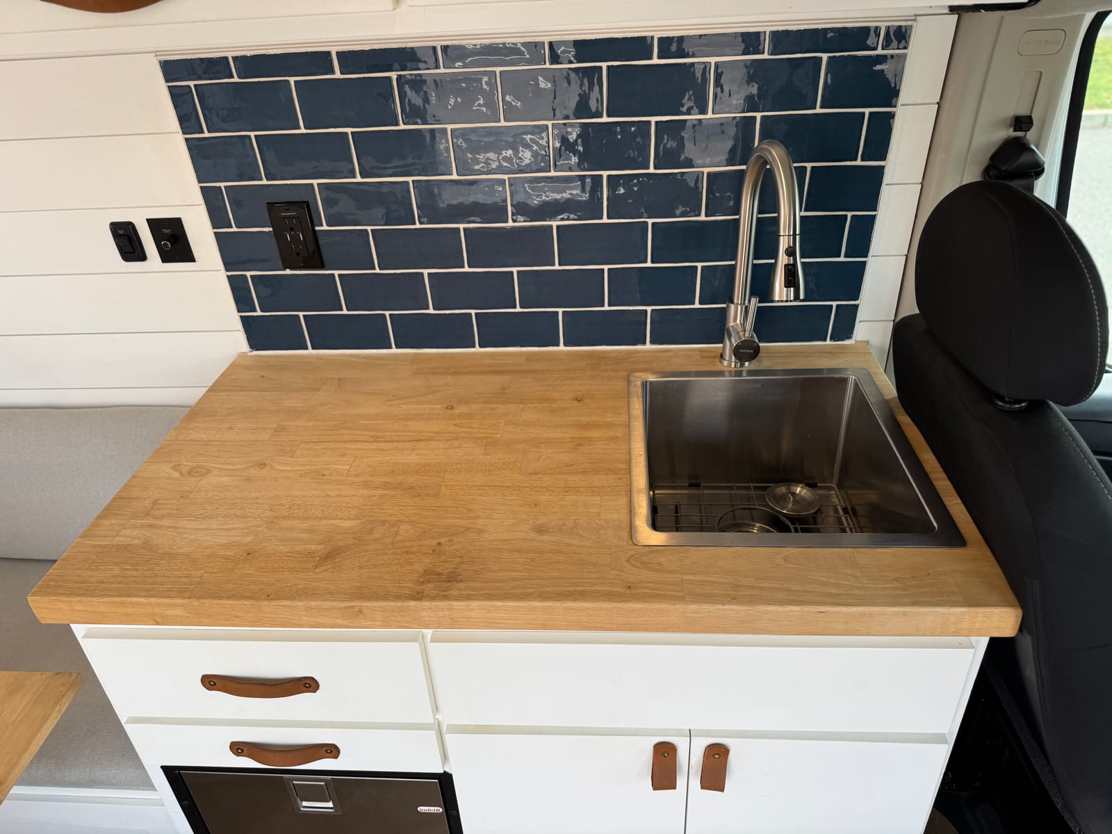 Deep stainless sink and retractable faucet in the wood galley counter