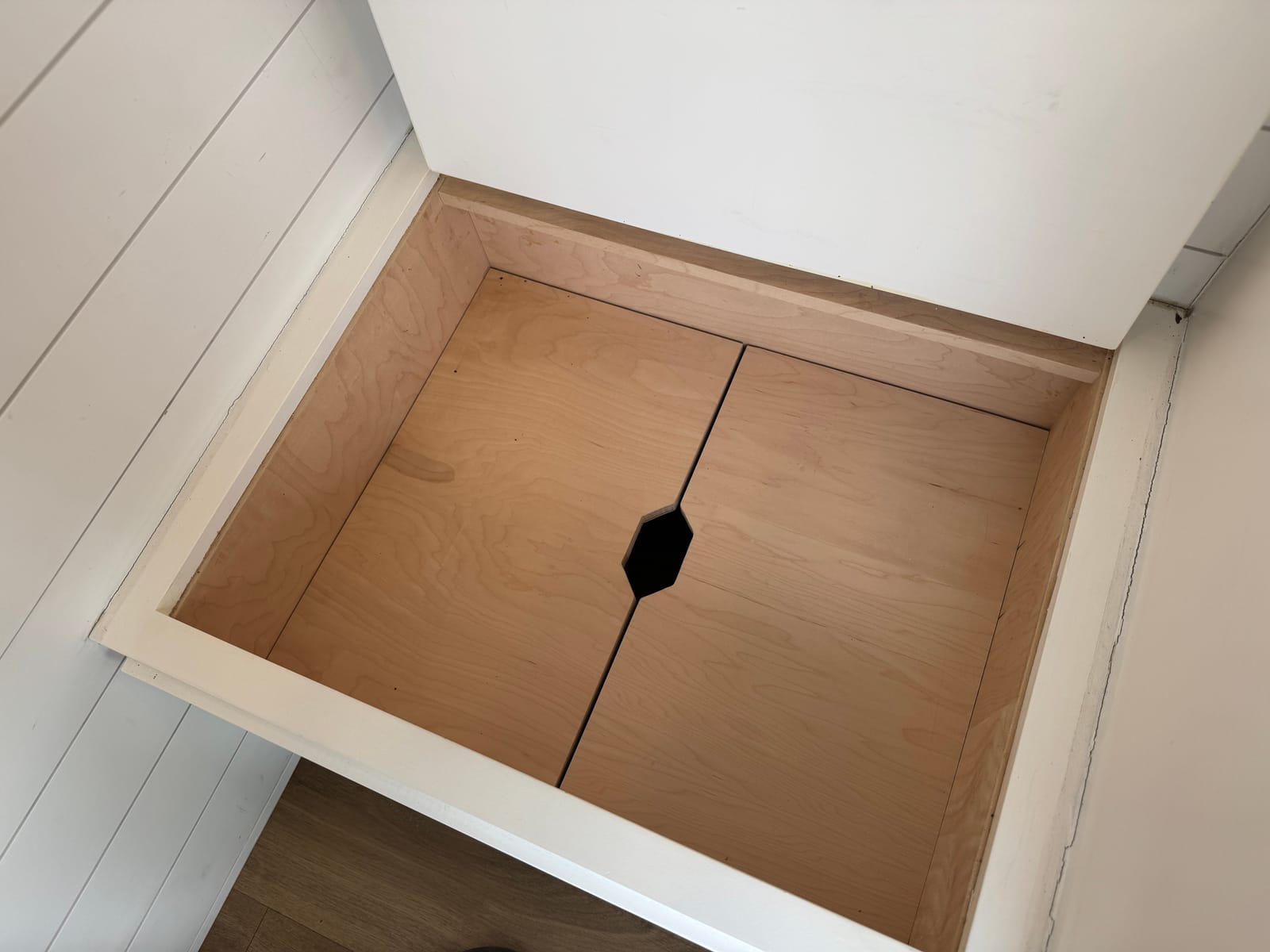 Interior floor hatch opening down into the gear garage