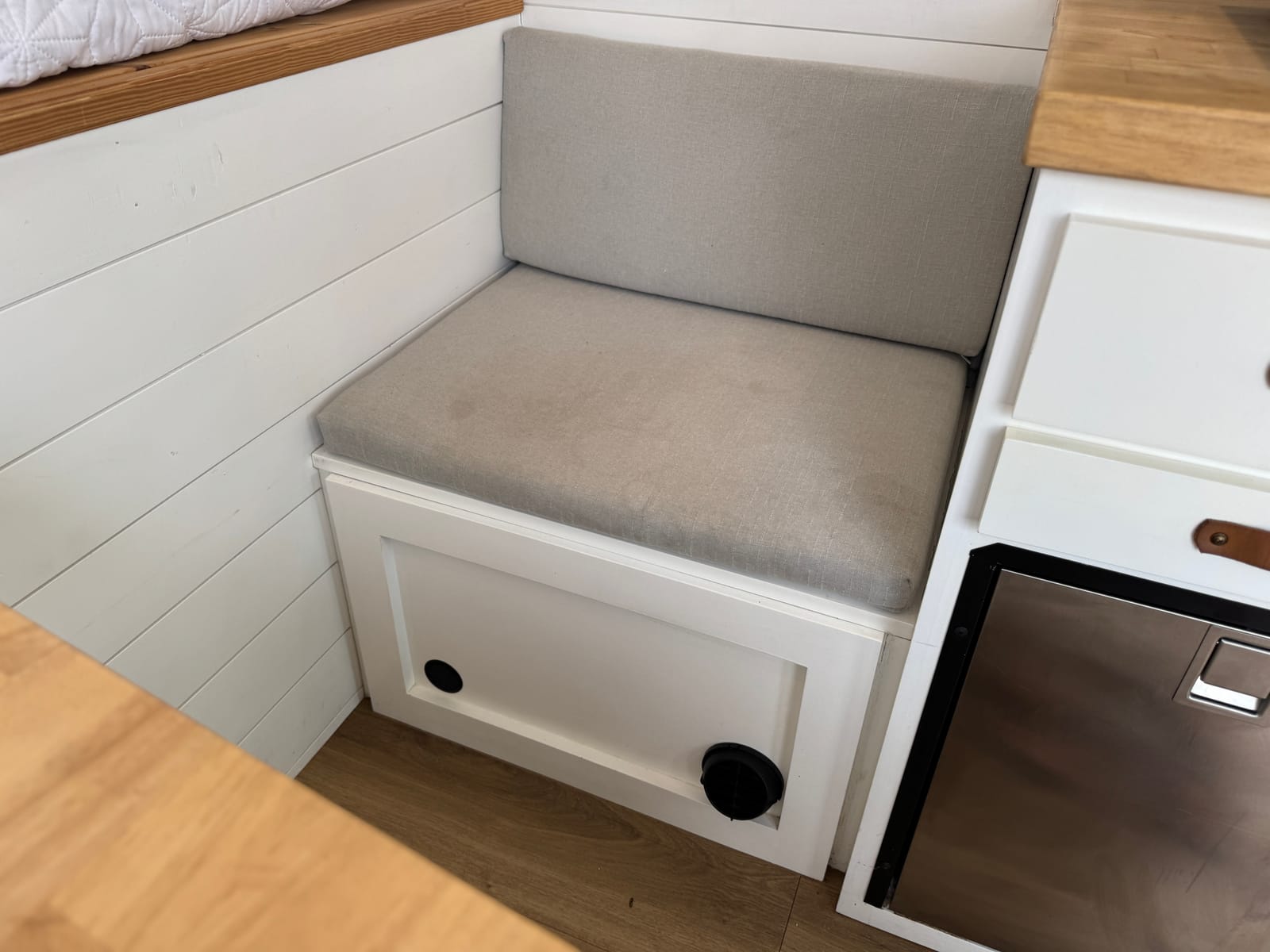 Lounge bench seat beside the galley with storage below