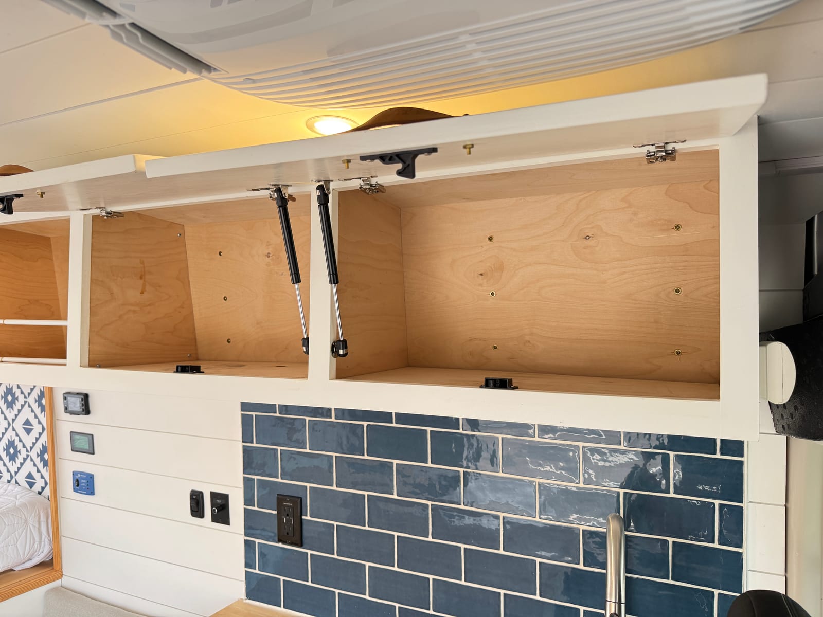 Overhead cabinet lockers open along the ceiling line