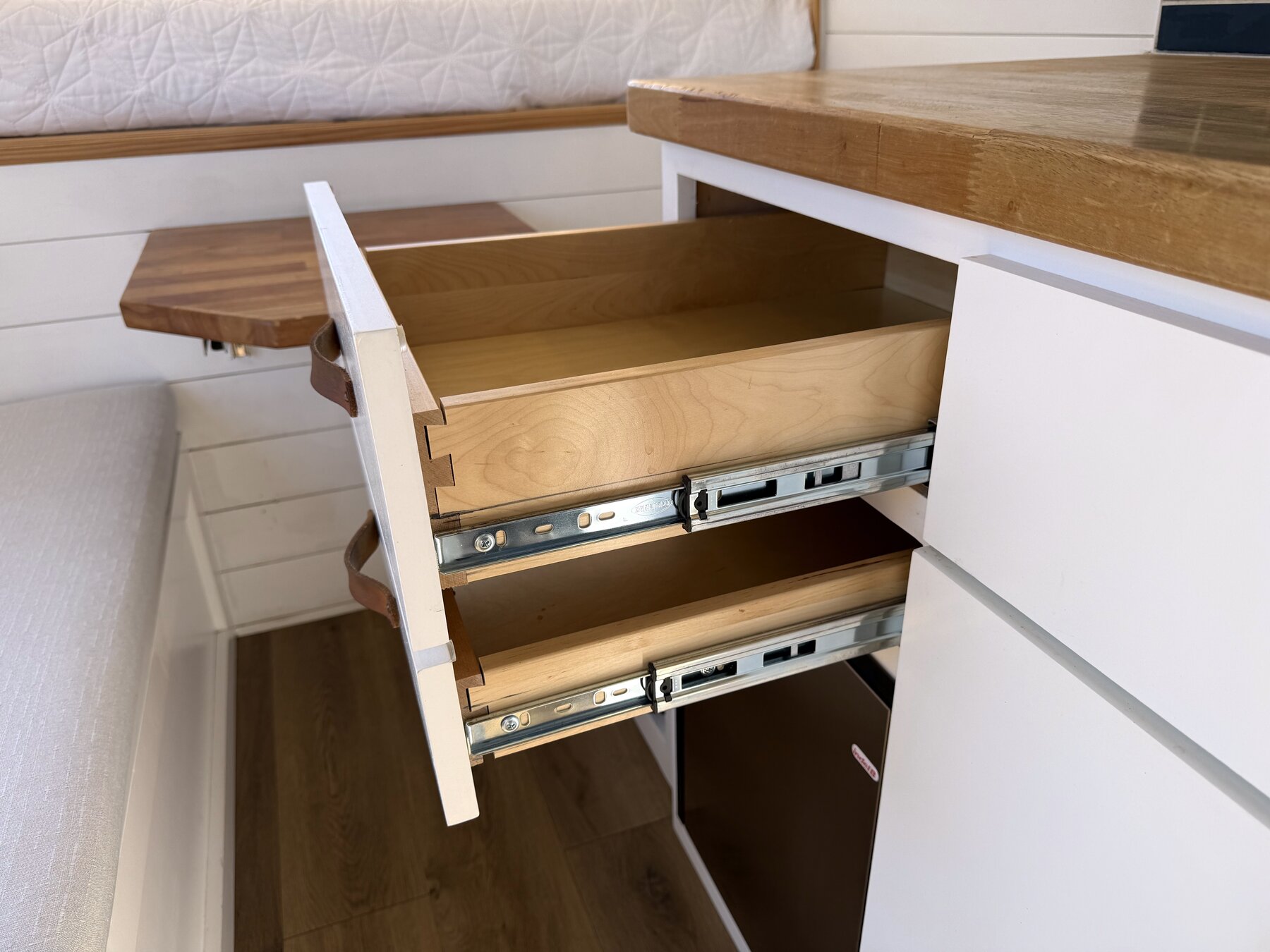 Two dovetailed drawers pulled open on full-extension slides