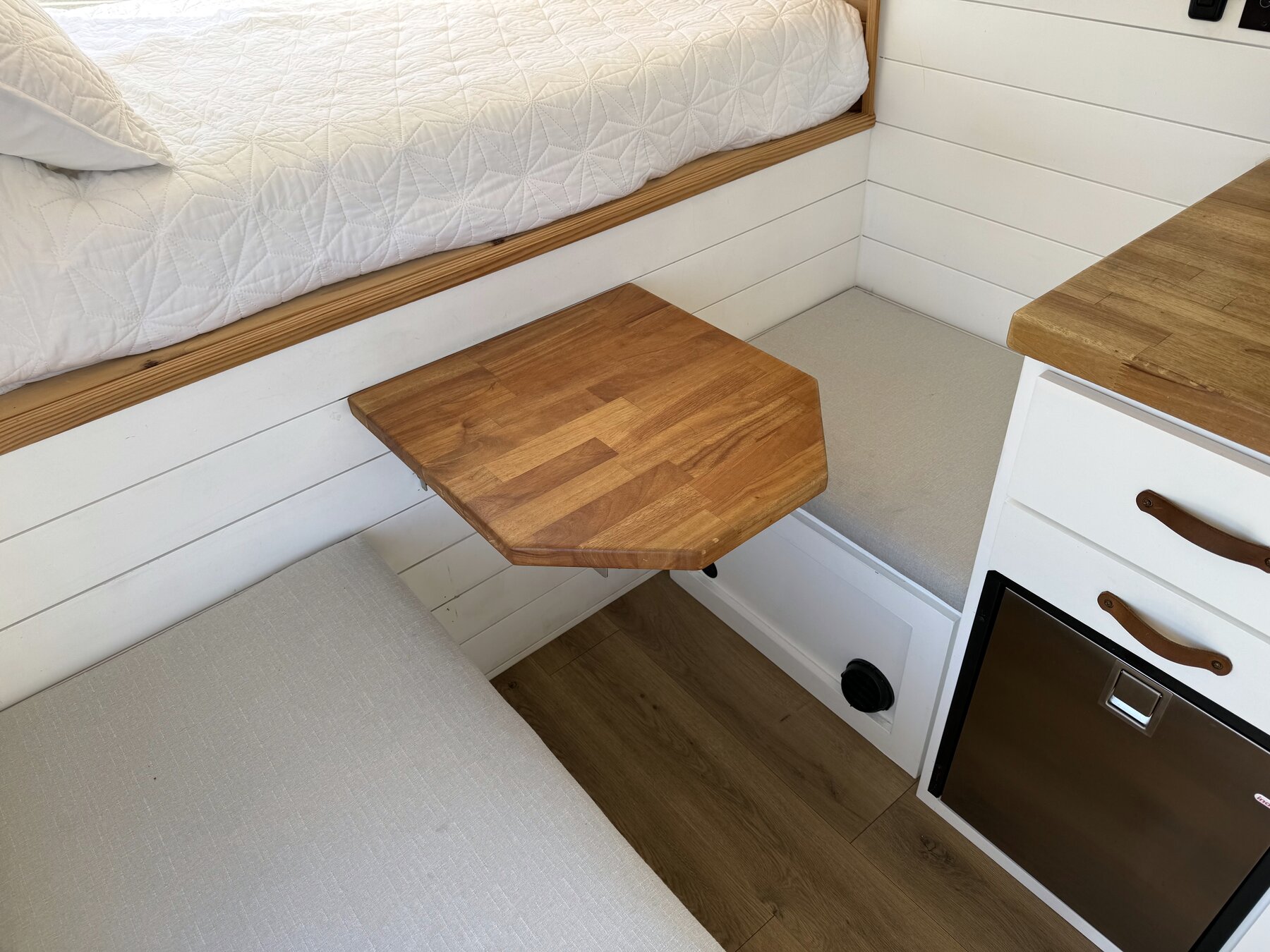 Wood fold-down table between the two bench seats